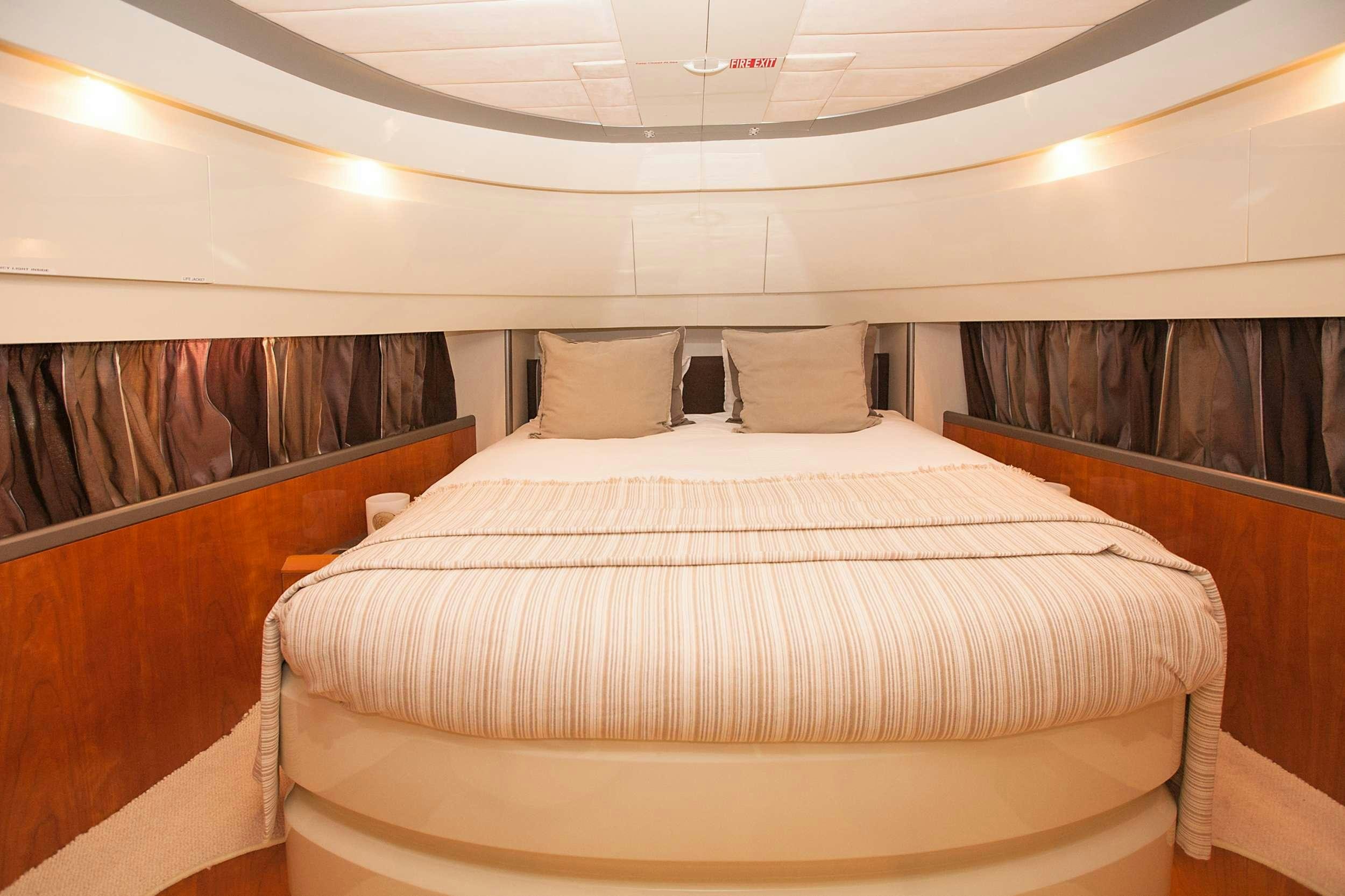 a bed with a white sheet and pillows aboard WHITE FANG Yacht for Charter
