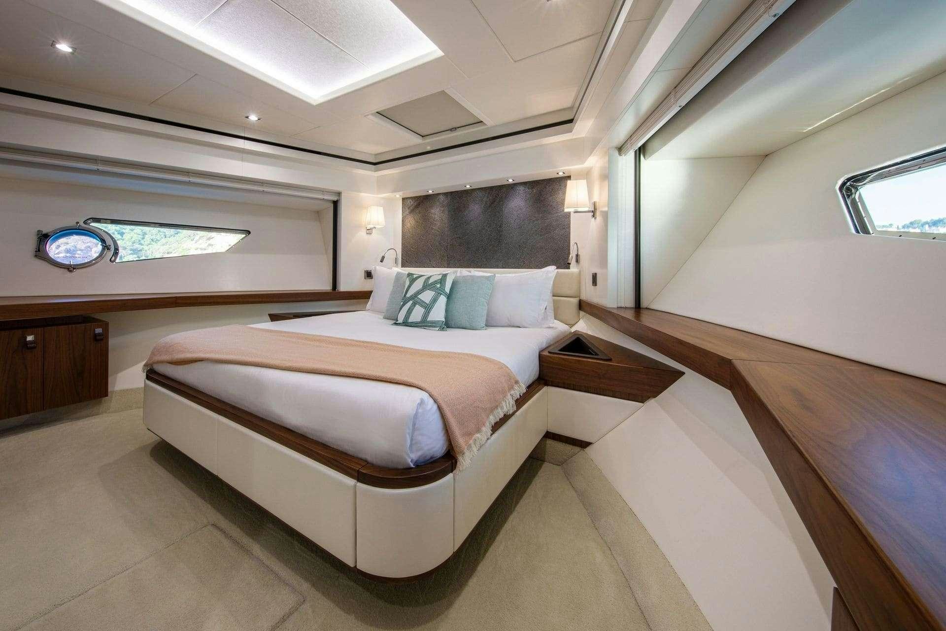 a room with a bed and a window aboard RUSH X Yacht for Charter