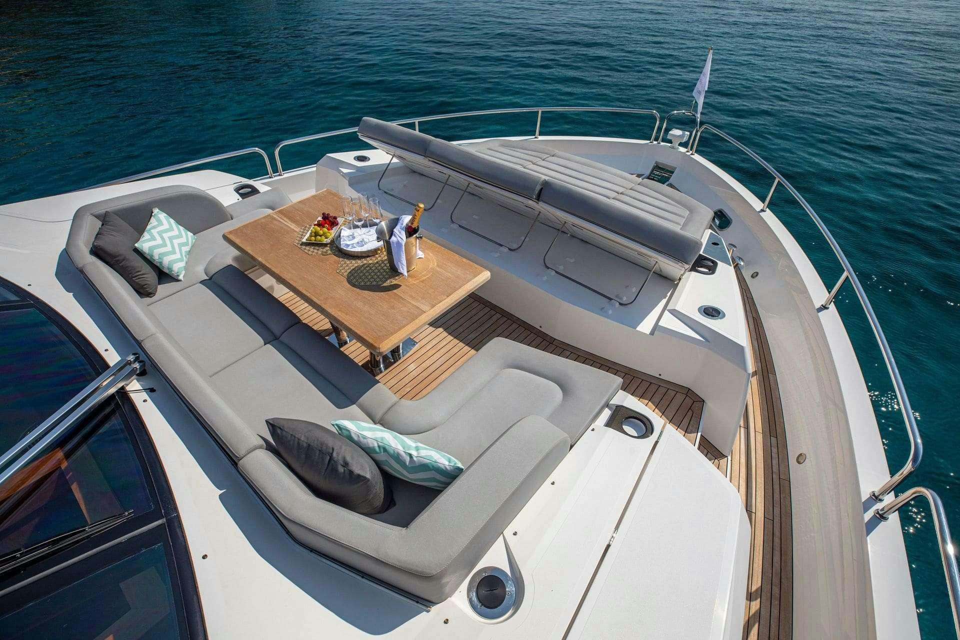 a boat with a table on the deck aboard RUSH X Yacht for Charter
