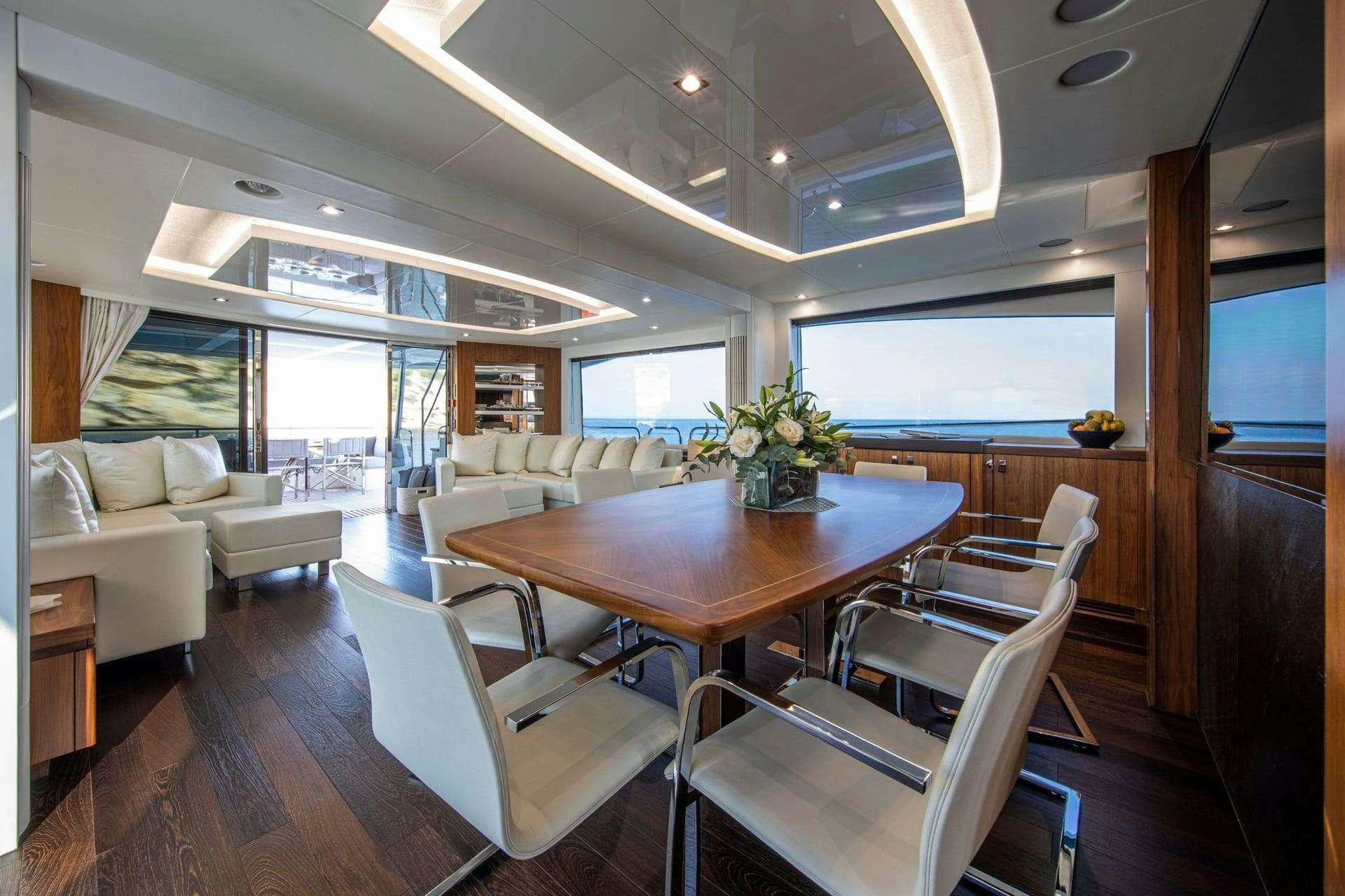a living room with a table and chairs aboard RUSH X Yacht for Charter