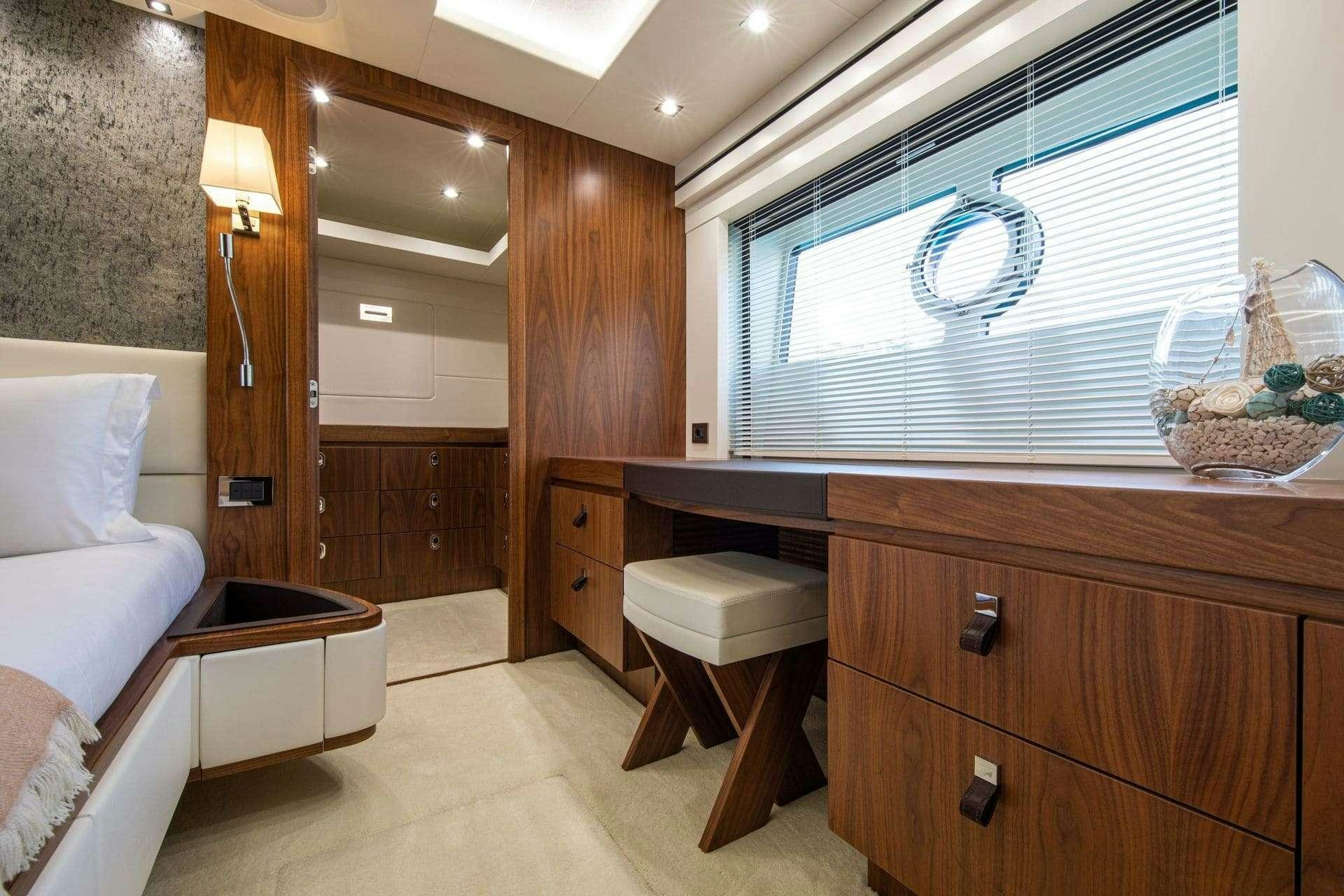 a room with a bed and a desk aboard RUSH X Yacht for Charter