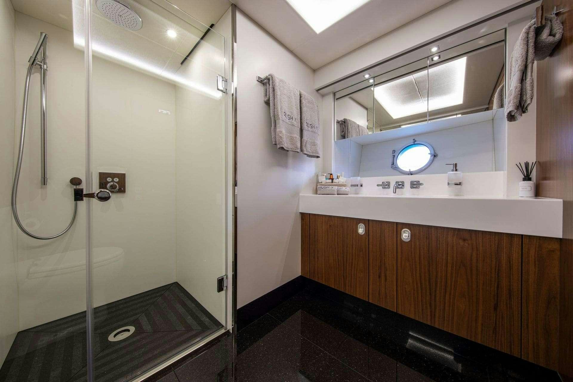 a bathroom with a shower unit aboard RUSH X Yacht for Charter
