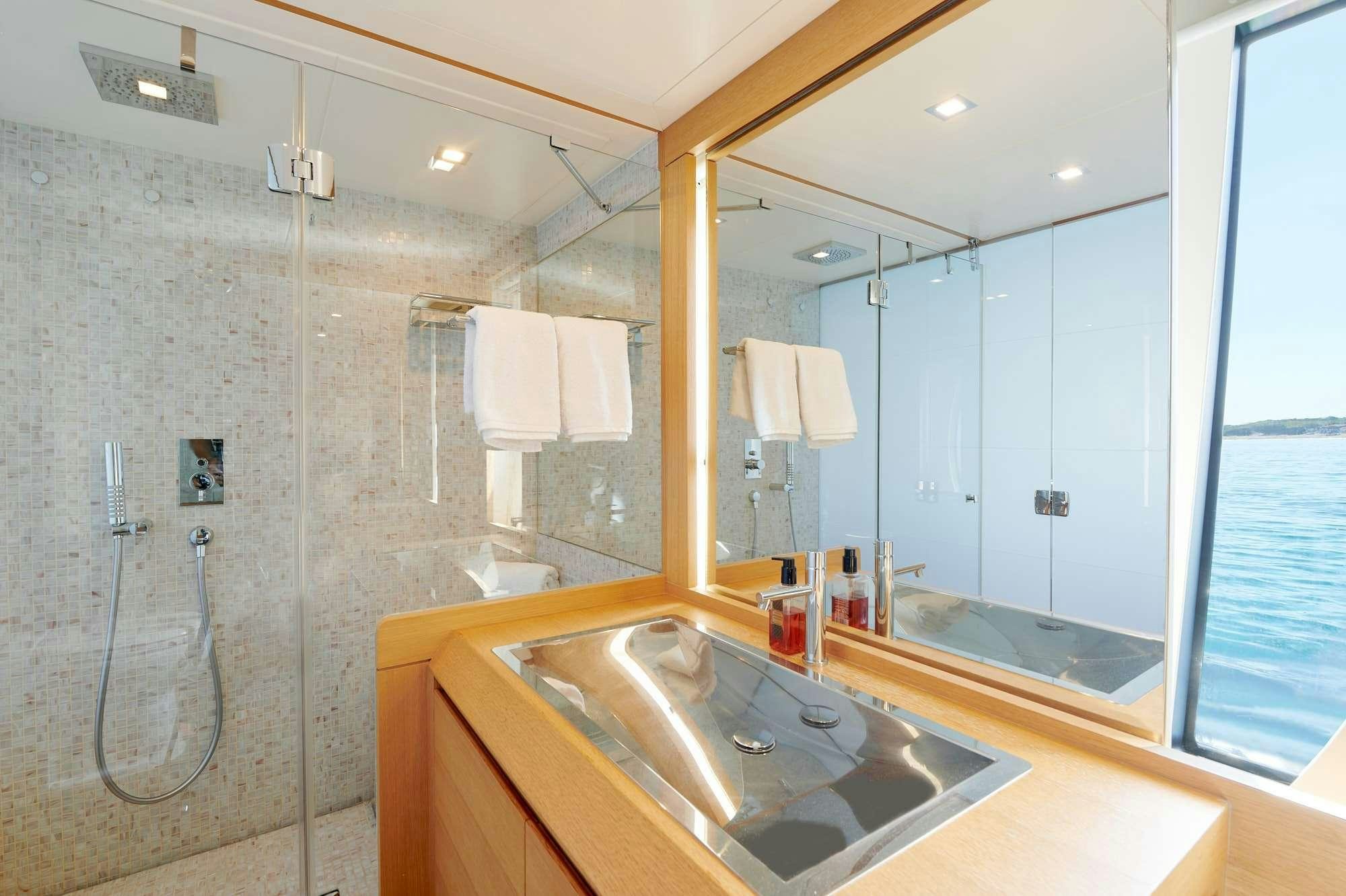 a bathroom with a large mirror aboard HALLEY Yacht for Charter