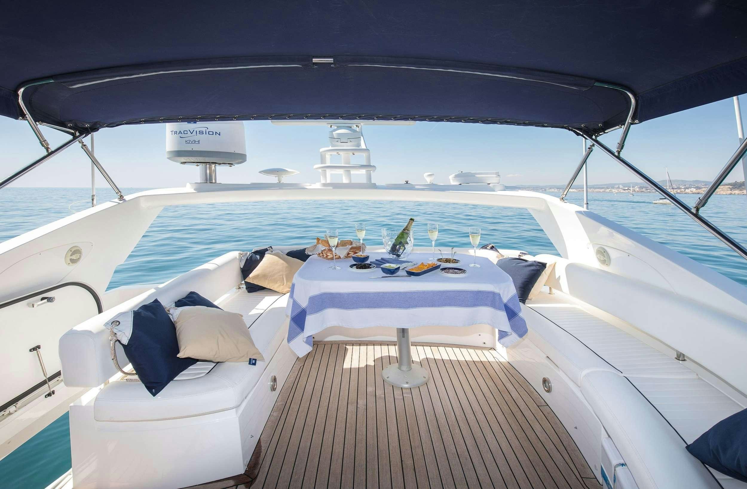 a boat with a table and chairs on the deck aboard MEDITERRANI IV Yacht for Charter