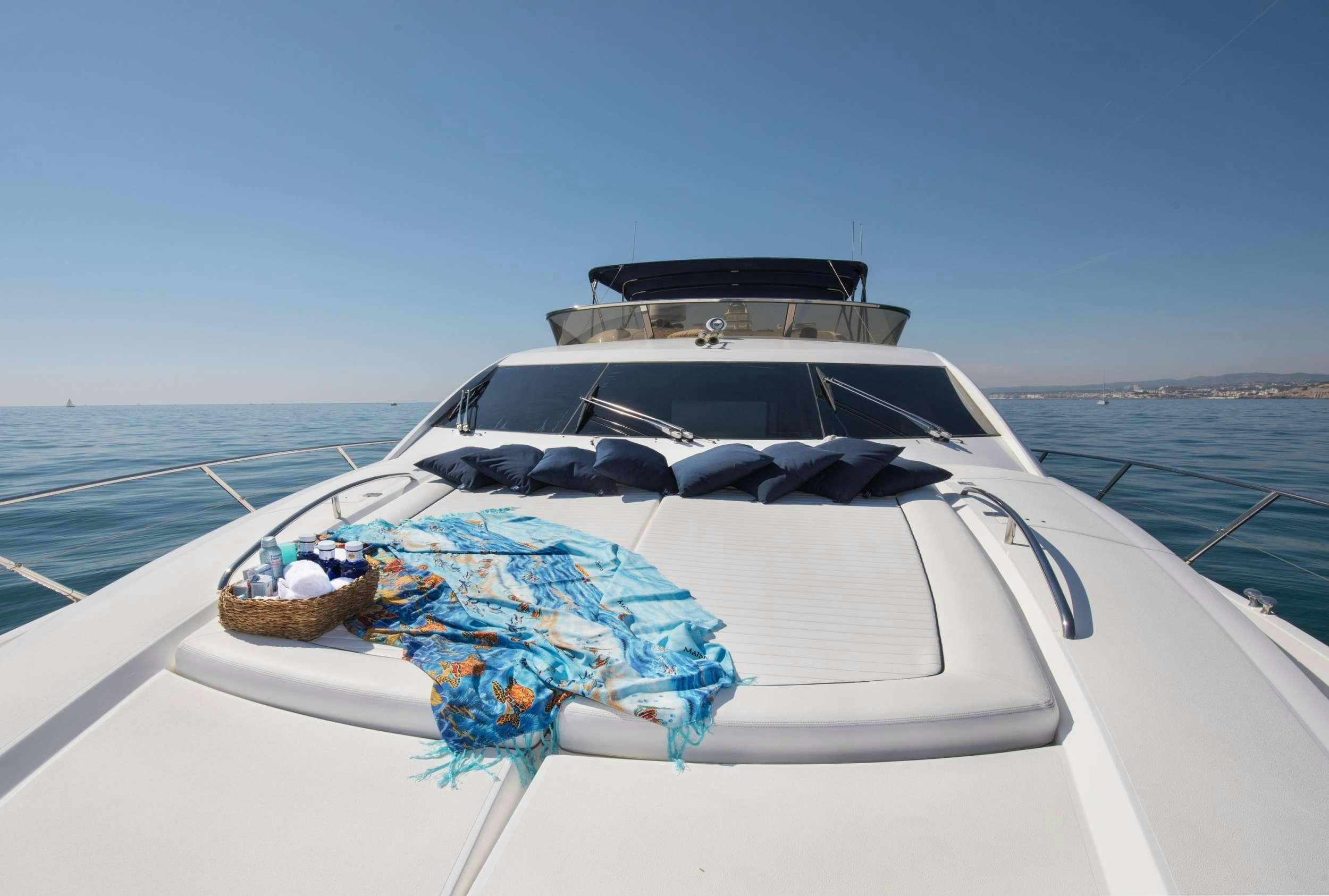 a boat with a blue umbrella on the front aboard MEDITERRANI IV Yacht for Charter