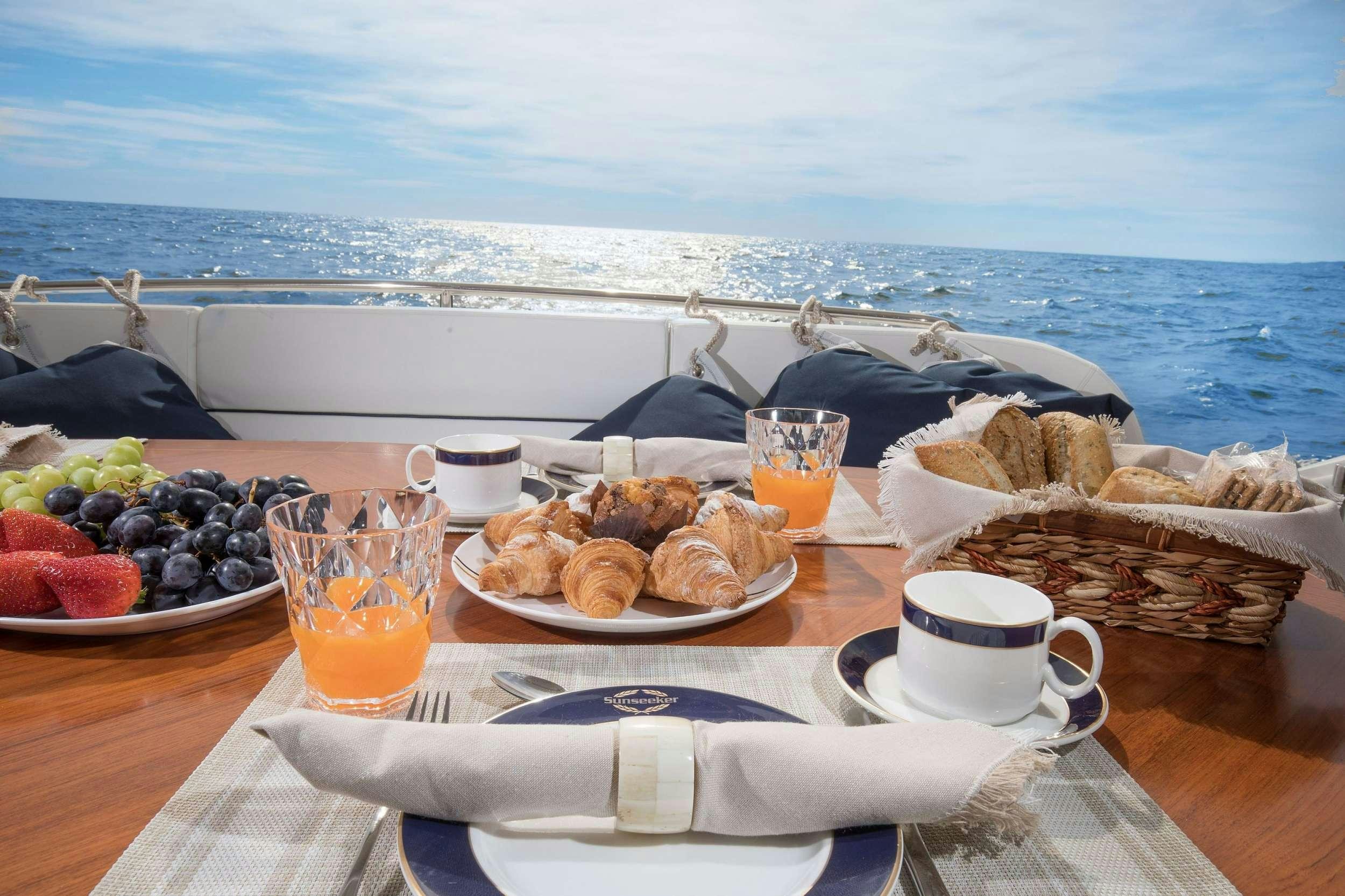 a table with food and drinks on it aboard MEDITERRANI IV Yacht for Charter