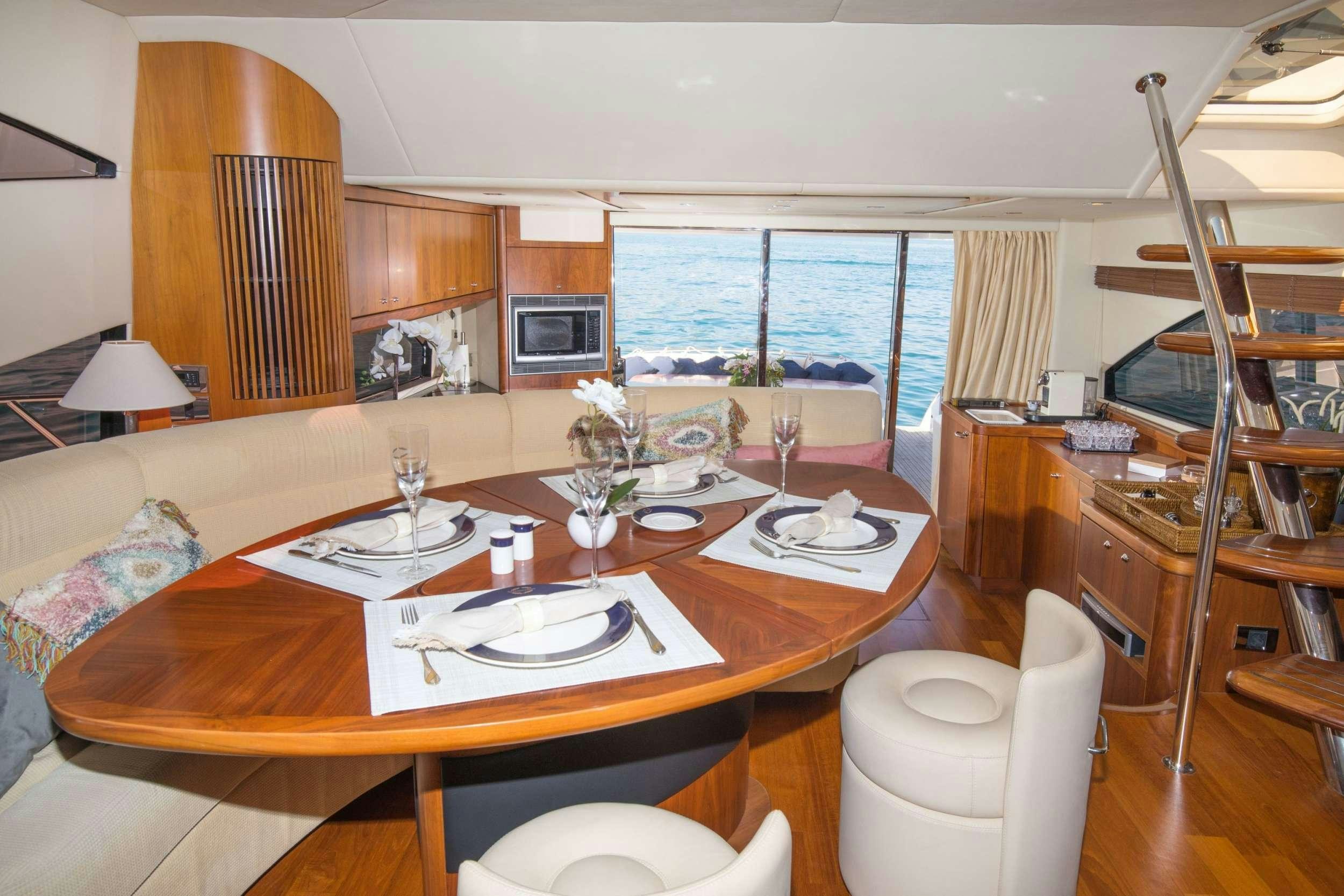 a dining table with plates and glasses aboard MEDITERRANI IV Yacht for Charter