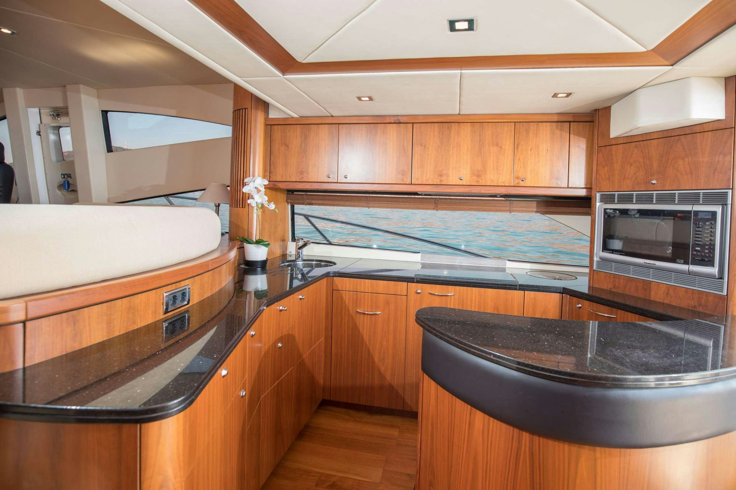 a kitchen with wooden cabinets aboard MEDITERRANI IV Yacht for Charter
