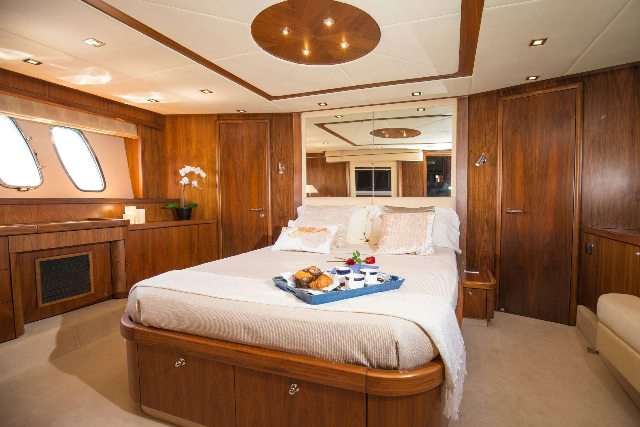 a bedroom with a bed and a fireplace aboard MEDITERRANI IV Yacht for Charter