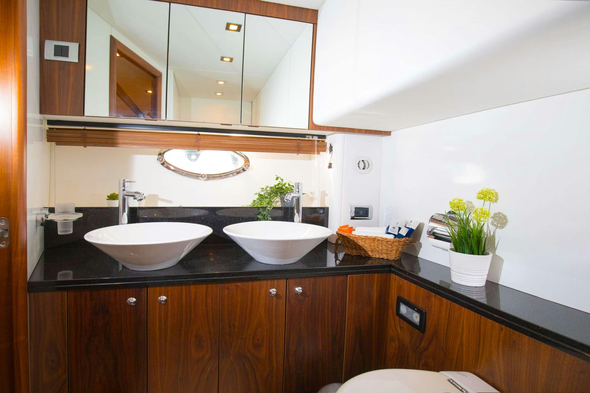 a bathroom with a sink and a mirror aboard MEDITERRANI IV Yacht for Charter