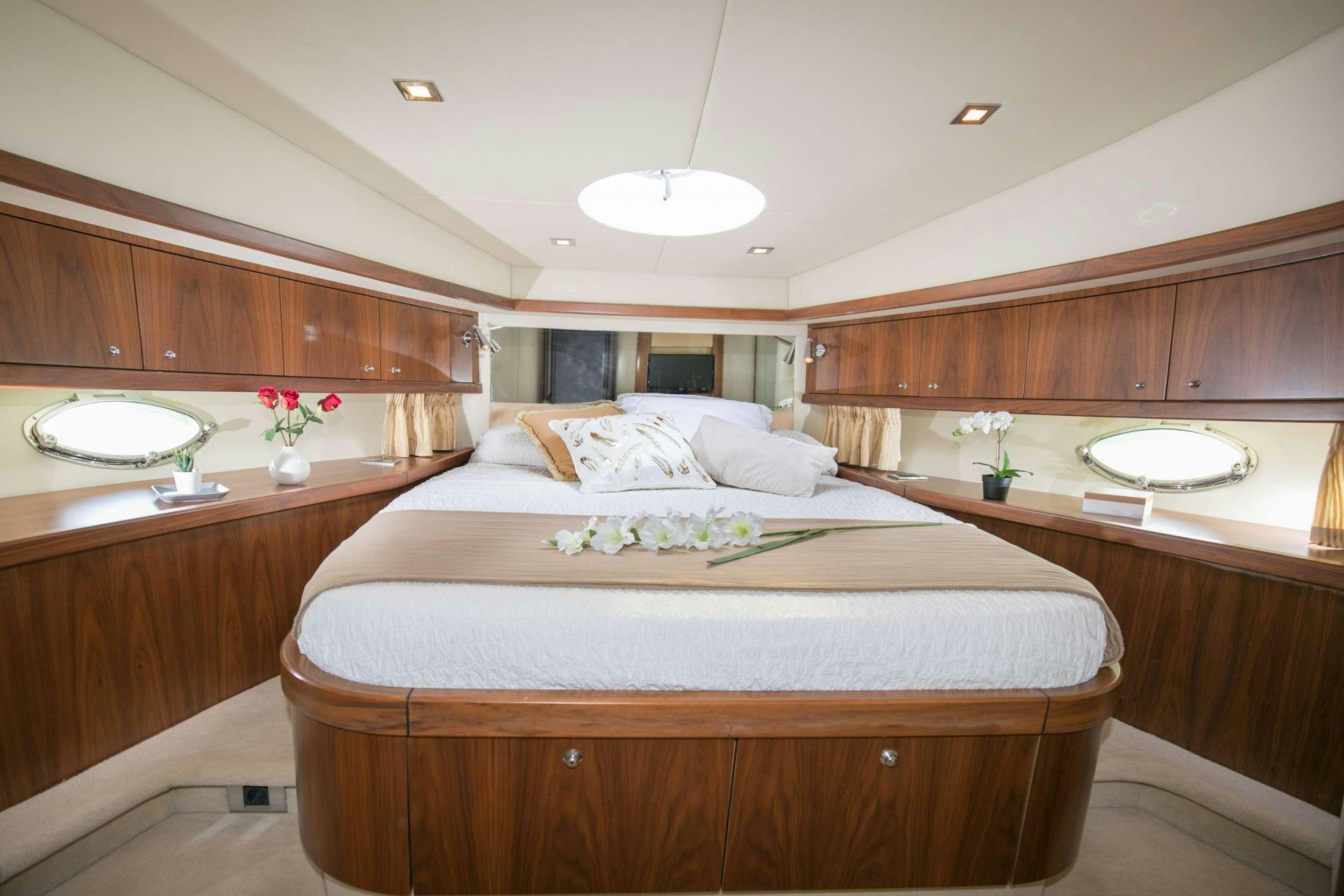 a room with a bed and a mirror aboard MEDITERRANI IV Yacht for Charter