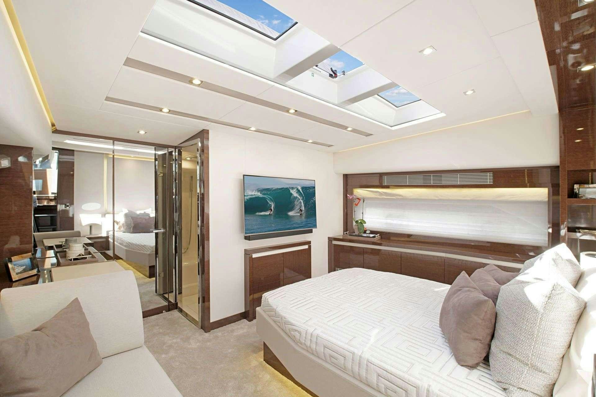 a room with a bed and a television aboard MO&EUML;T Yacht for Charter
