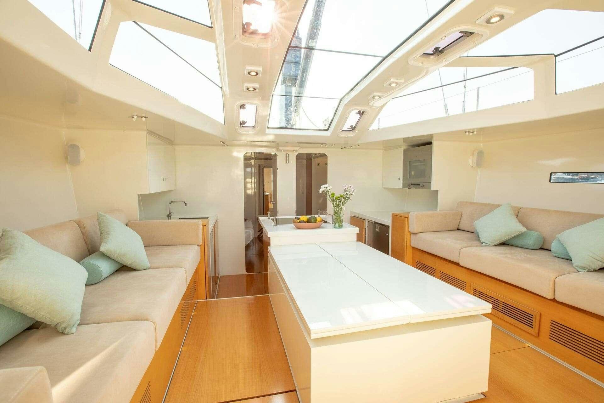 a room with a couch and a table aboard MIYABI Yacht for Charter