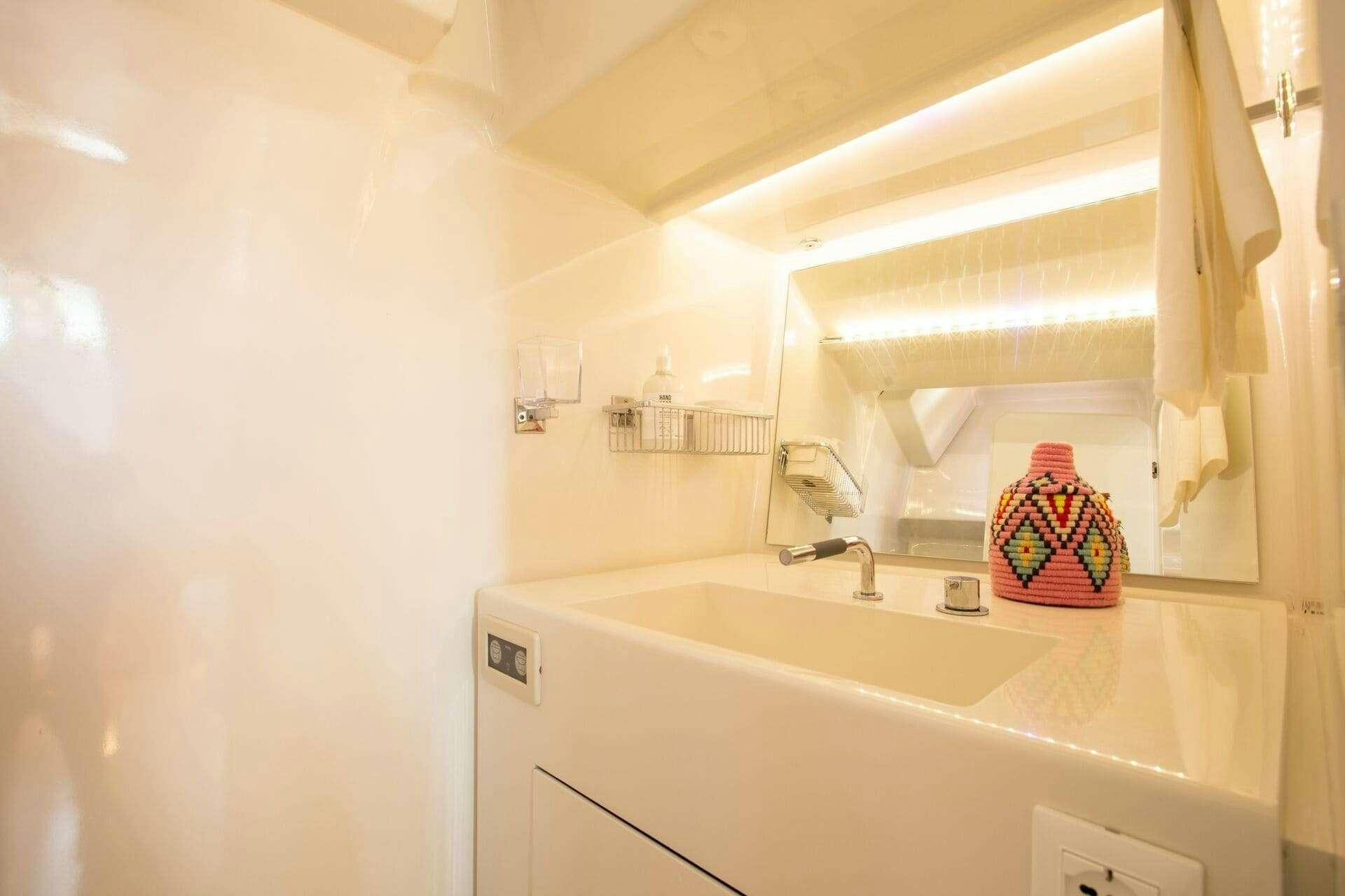 a bathroom with a sink and a mirror aboard MIYABI Yacht for Charter