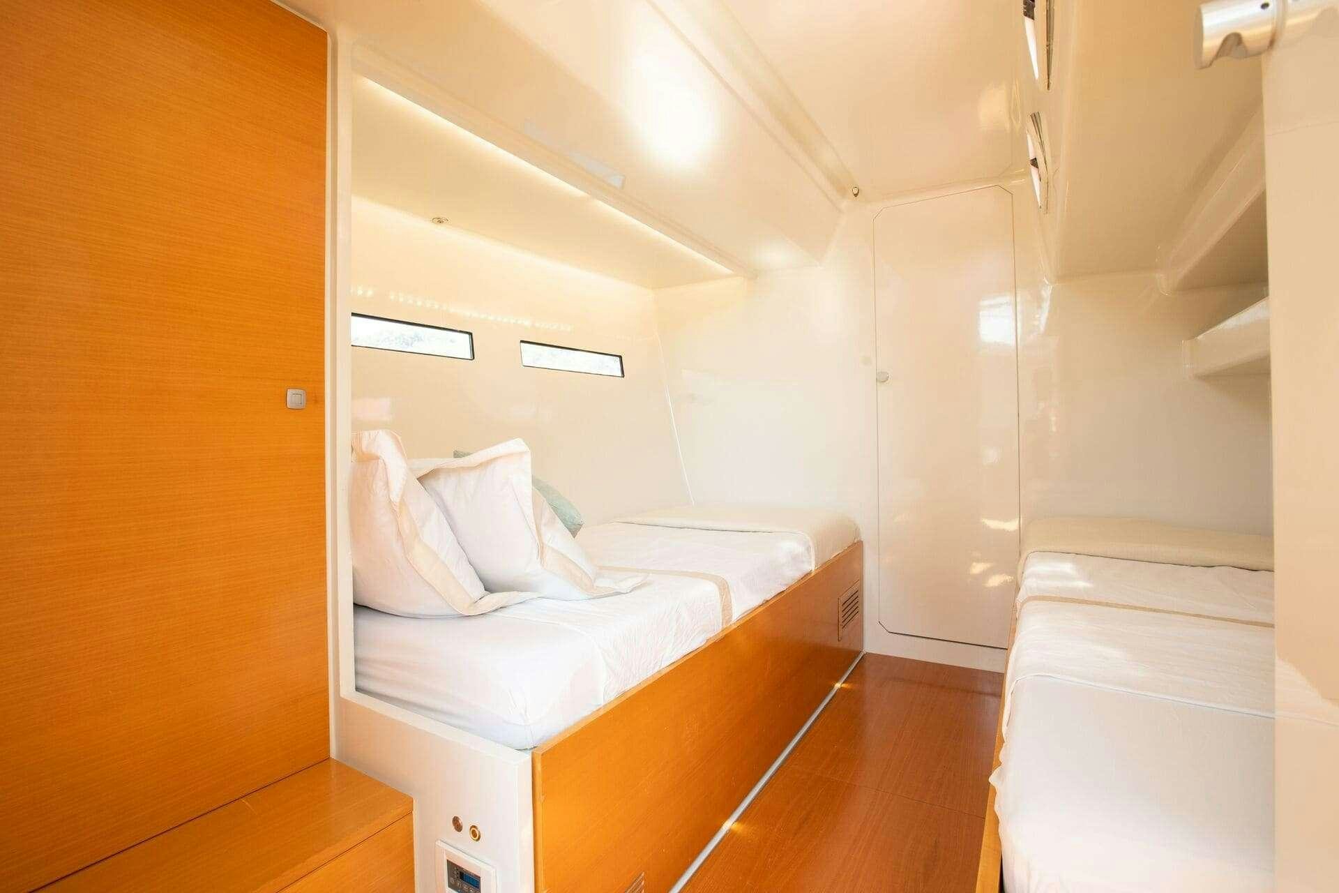 a room with a bed and a closet aboard MIYABI Yacht for Charter