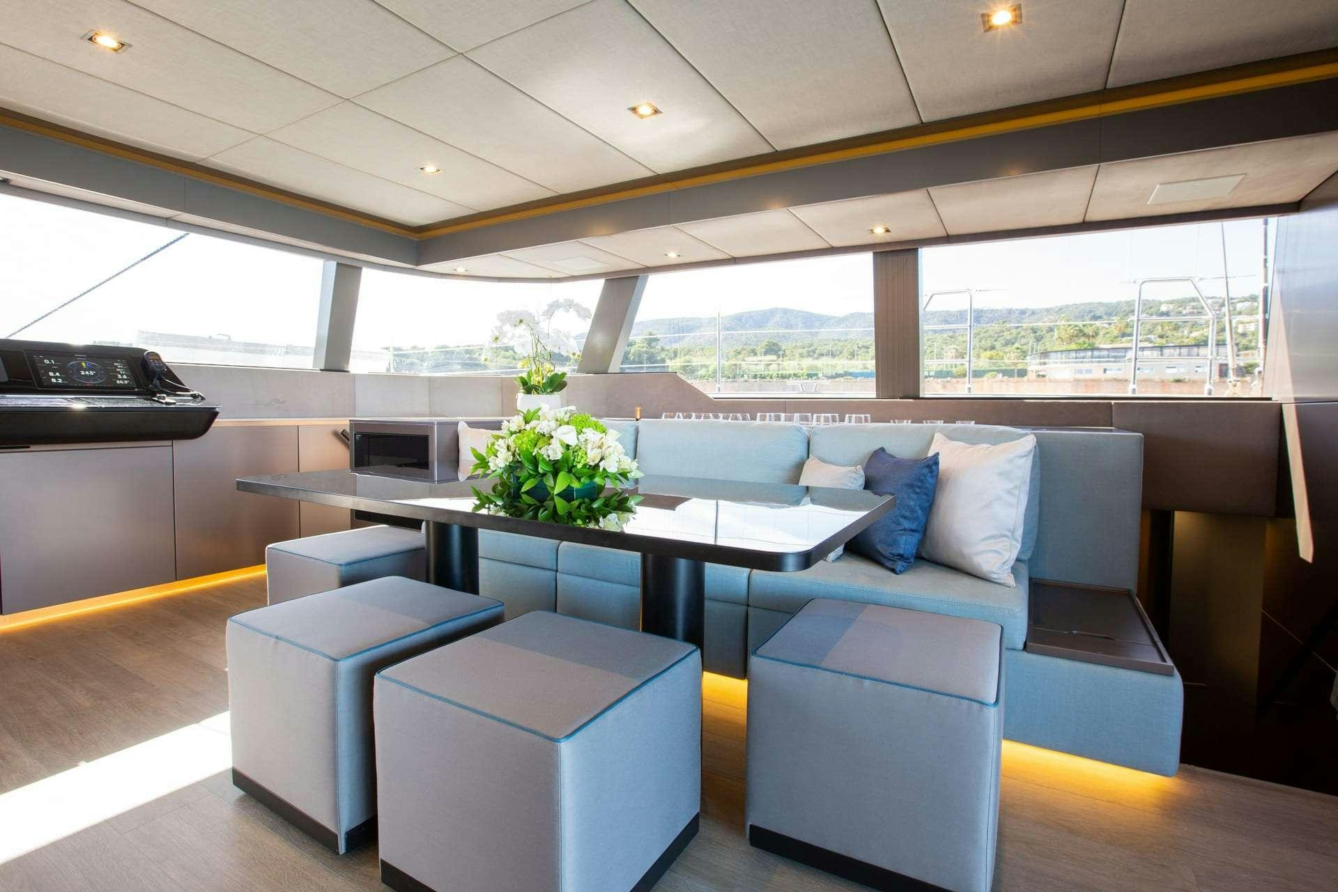 a room with a table and chairs aboard SUNBREEZE Yacht for Charter