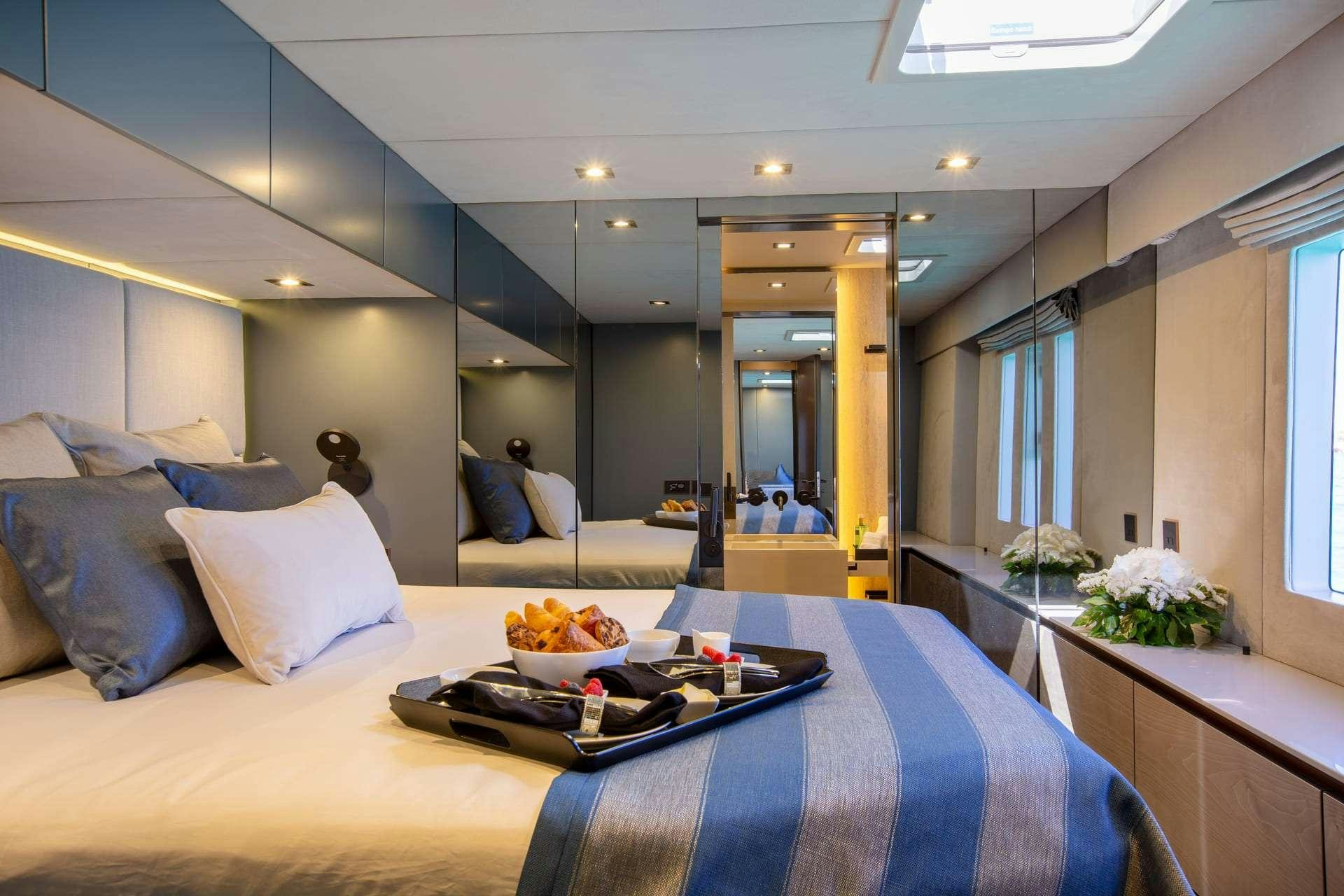 a bed with a tray of food on it aboard SUNBREEZE Yacht for Charter