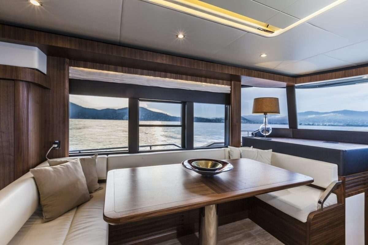 a room with a table and a view of the ocean aboard MAYBE5 Yacht for Charter