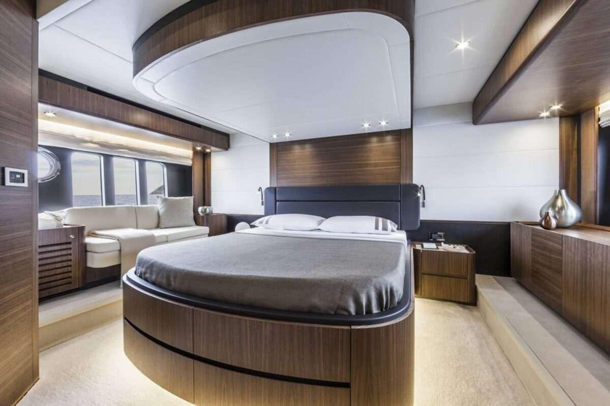 a bedroom with a bed and a couch aboard MAYBE5 Yacht for Charter