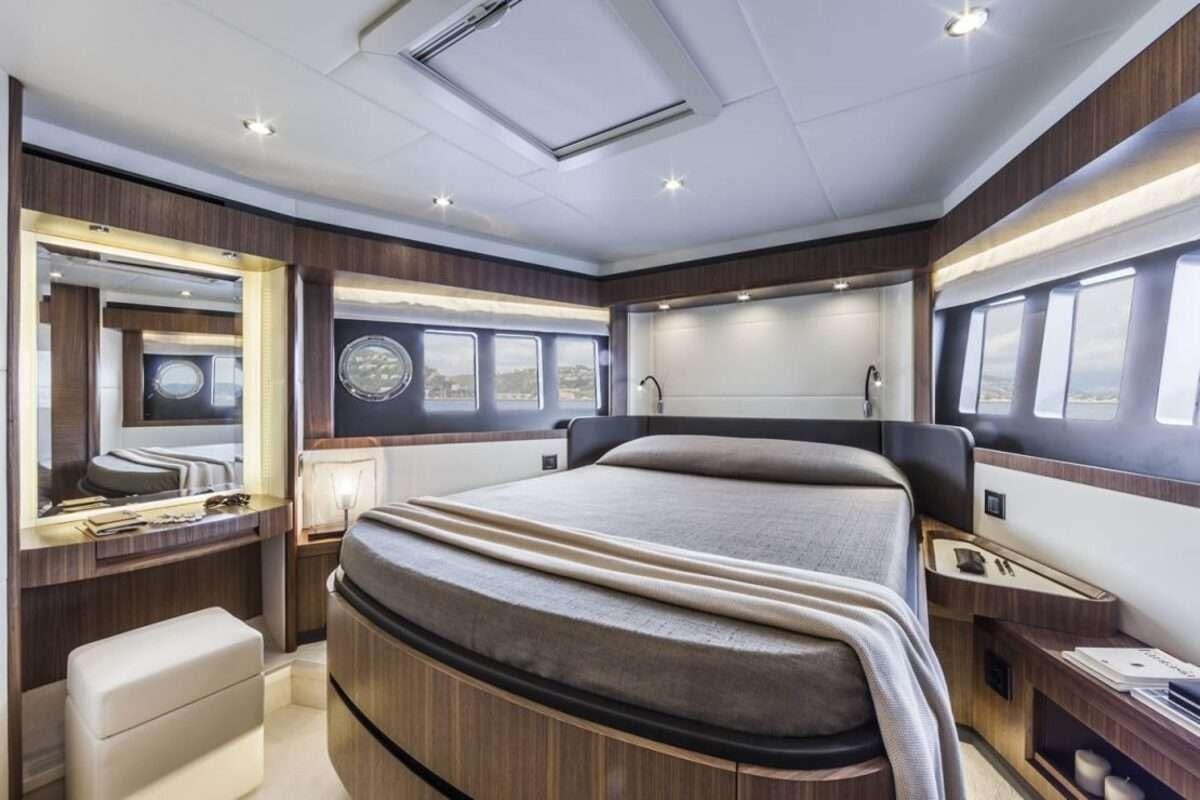 a room with a bed and a desk aboard MAYBE5 Yacht for Charter