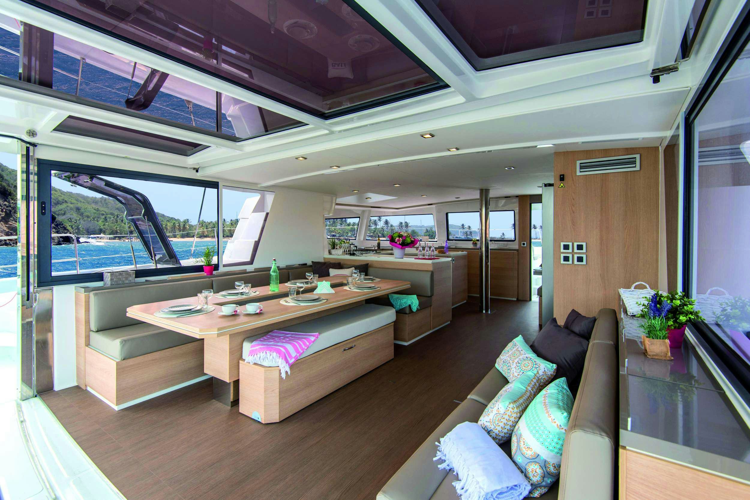 a modern living room with a large open window aboard AMURA Yacht for Charter