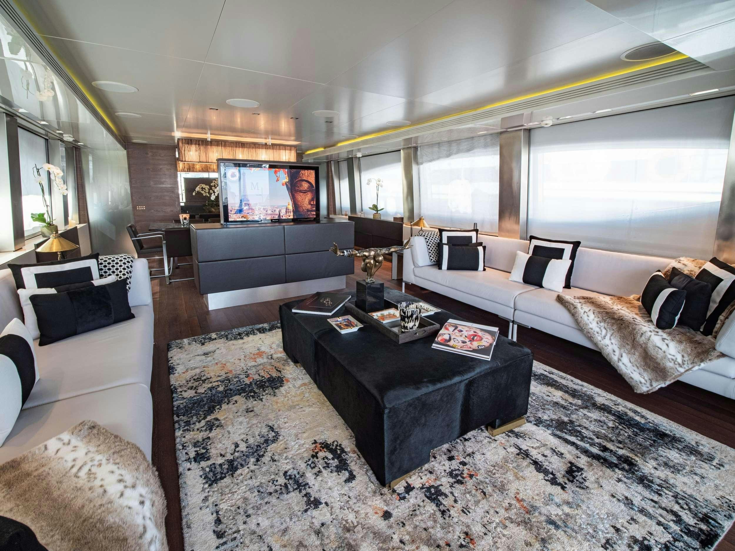 a living room with a large tv aboard M Yacht for Charter