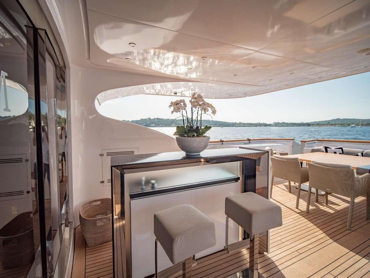 a room with a table and chairs aboard M Yacht for Charter