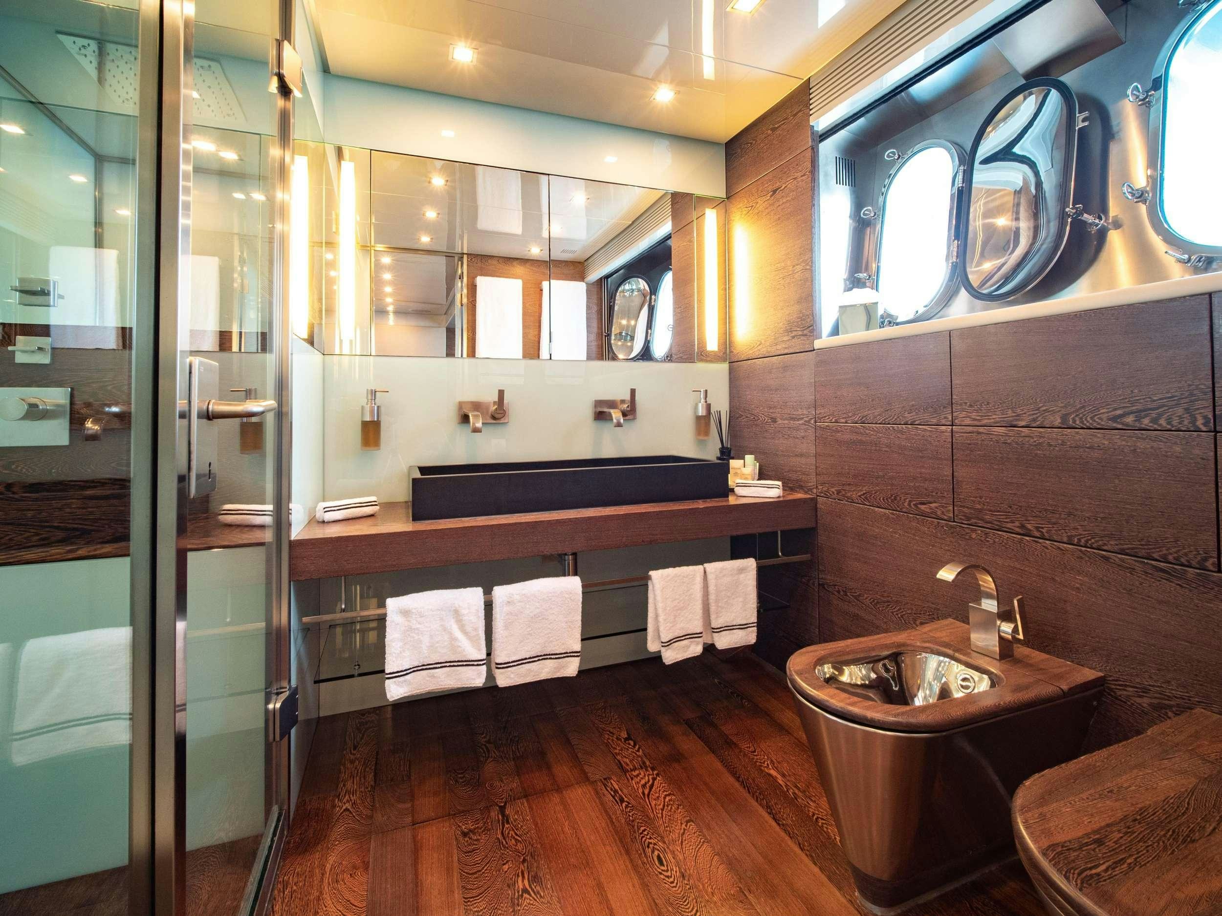 a bathroom with a glass shower aboard M Yacht for Charter