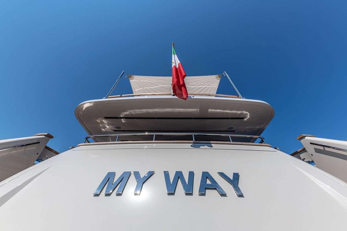 a boat with a flag on the front aboard MY WAY Yacht for Charter