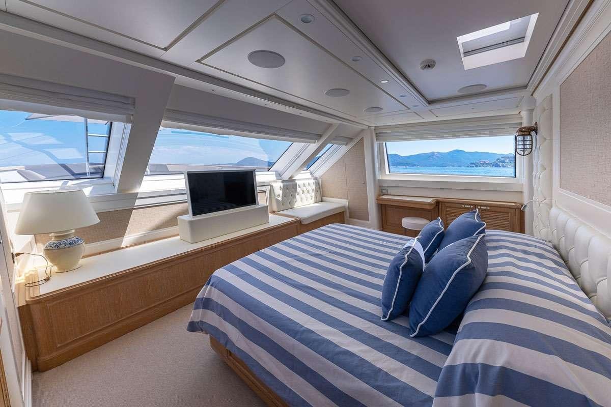 a room with a bed and a window aboard MY WAY Yacht for Charter