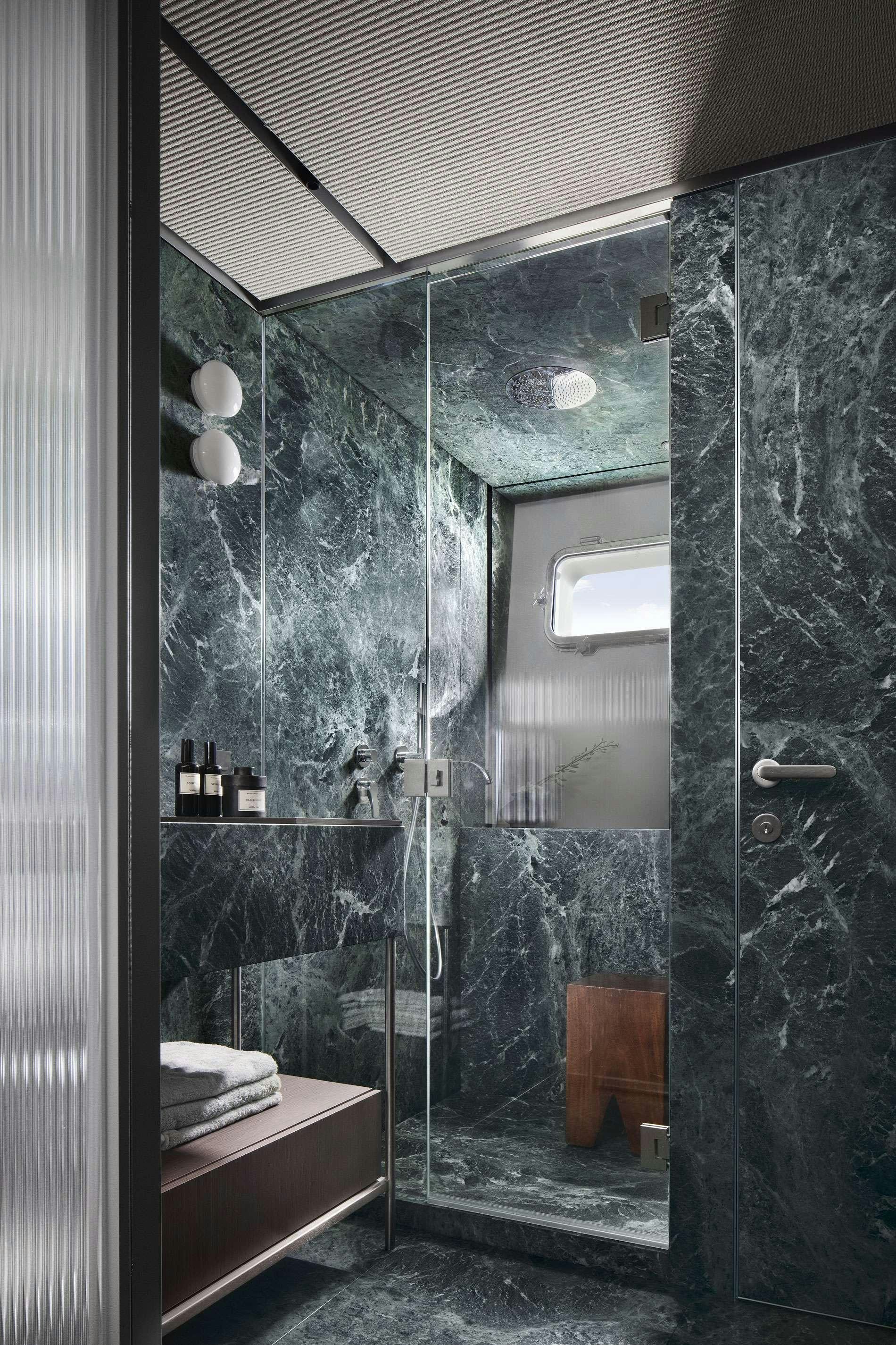 a bathroom with a glass shower aboard ALMAX Yacht for Charter