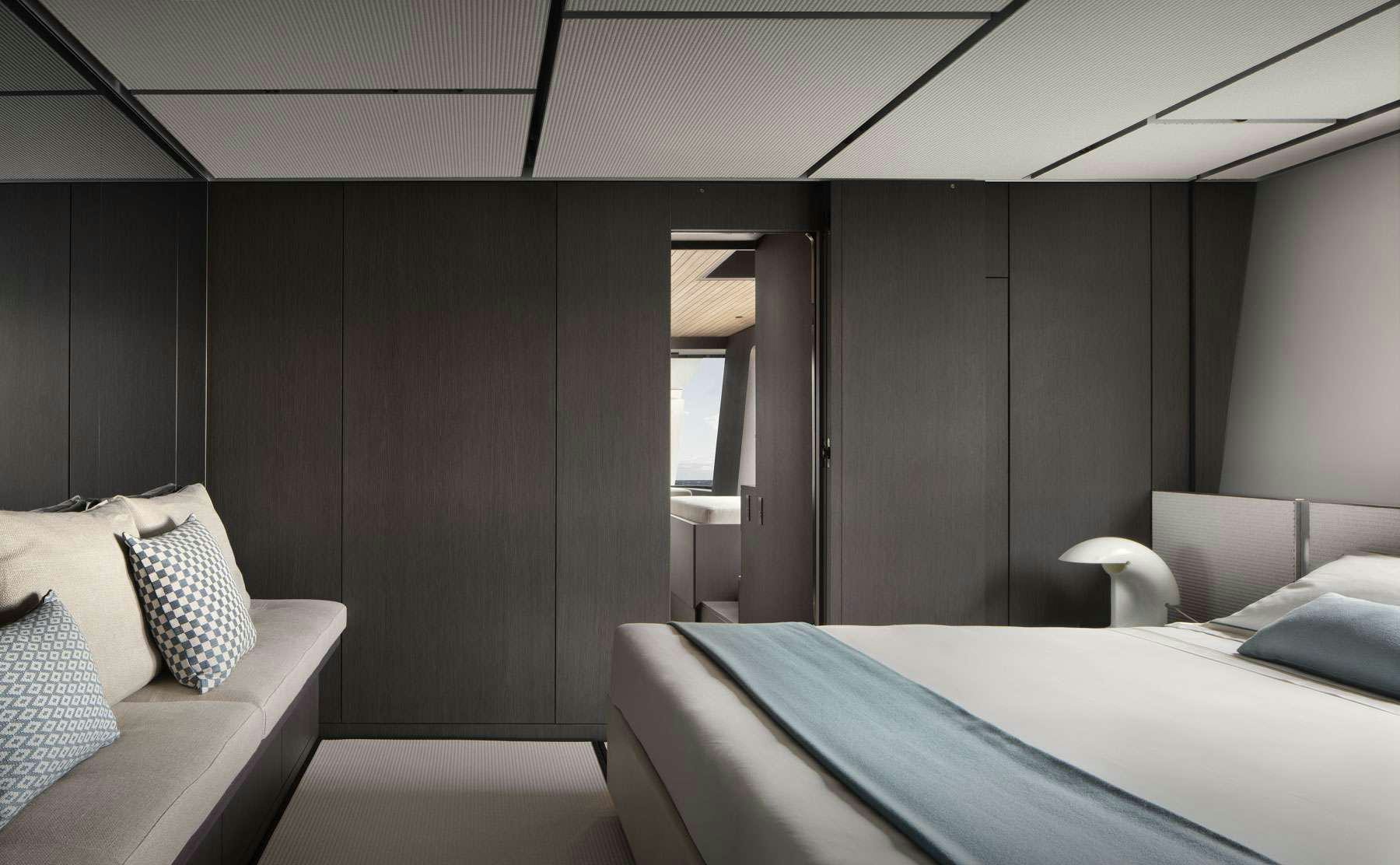 a room with a bed and a couch aboard ALMAX Yacht for Charter