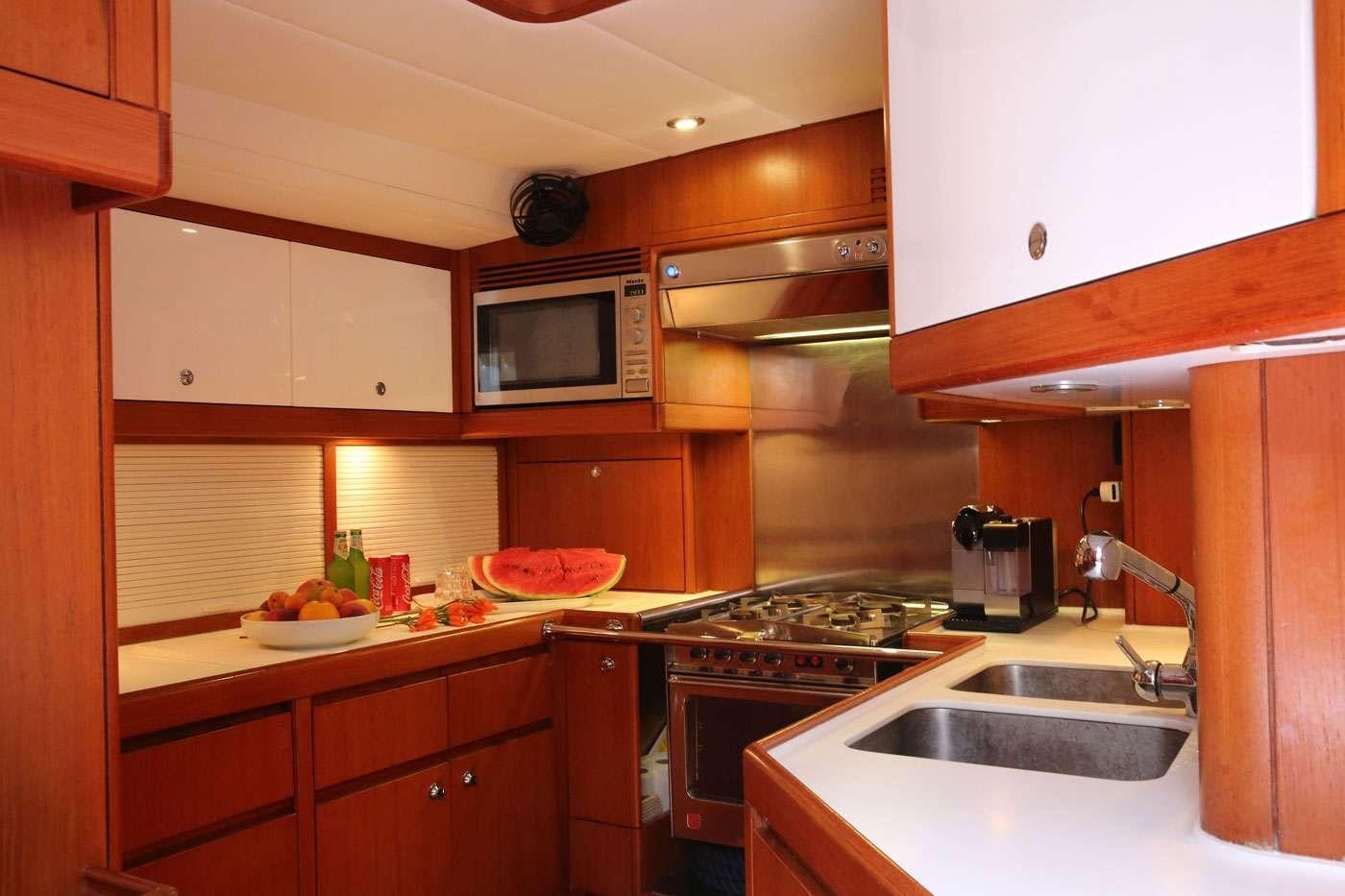 a kitchen with a stove and microwave aboard SOUTHERN STAR Yacht for Charter