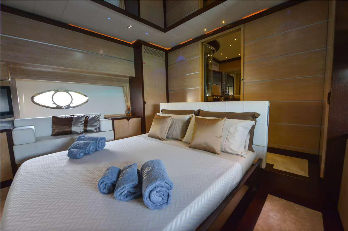 a bed with pillows on it aboard BLACK MAGIC Yacht for Charter