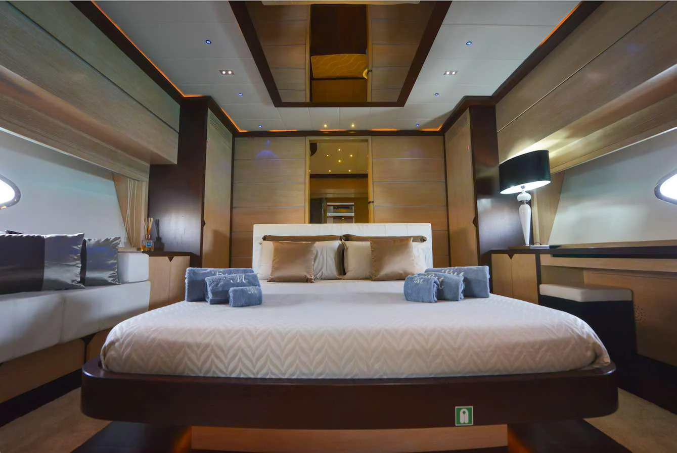 a room with a bed and a couch aboard BLACK MAGIC Yacht for Charter