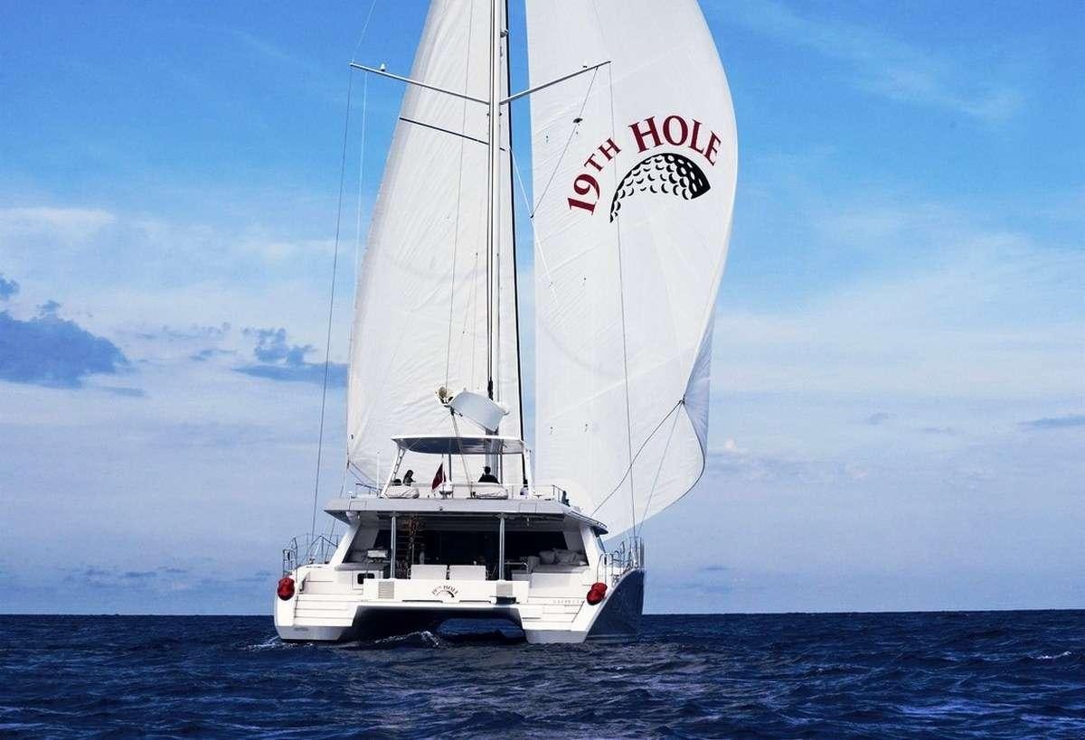 a sailboat in the water aboard 19TH HOLE Yacht for Charter