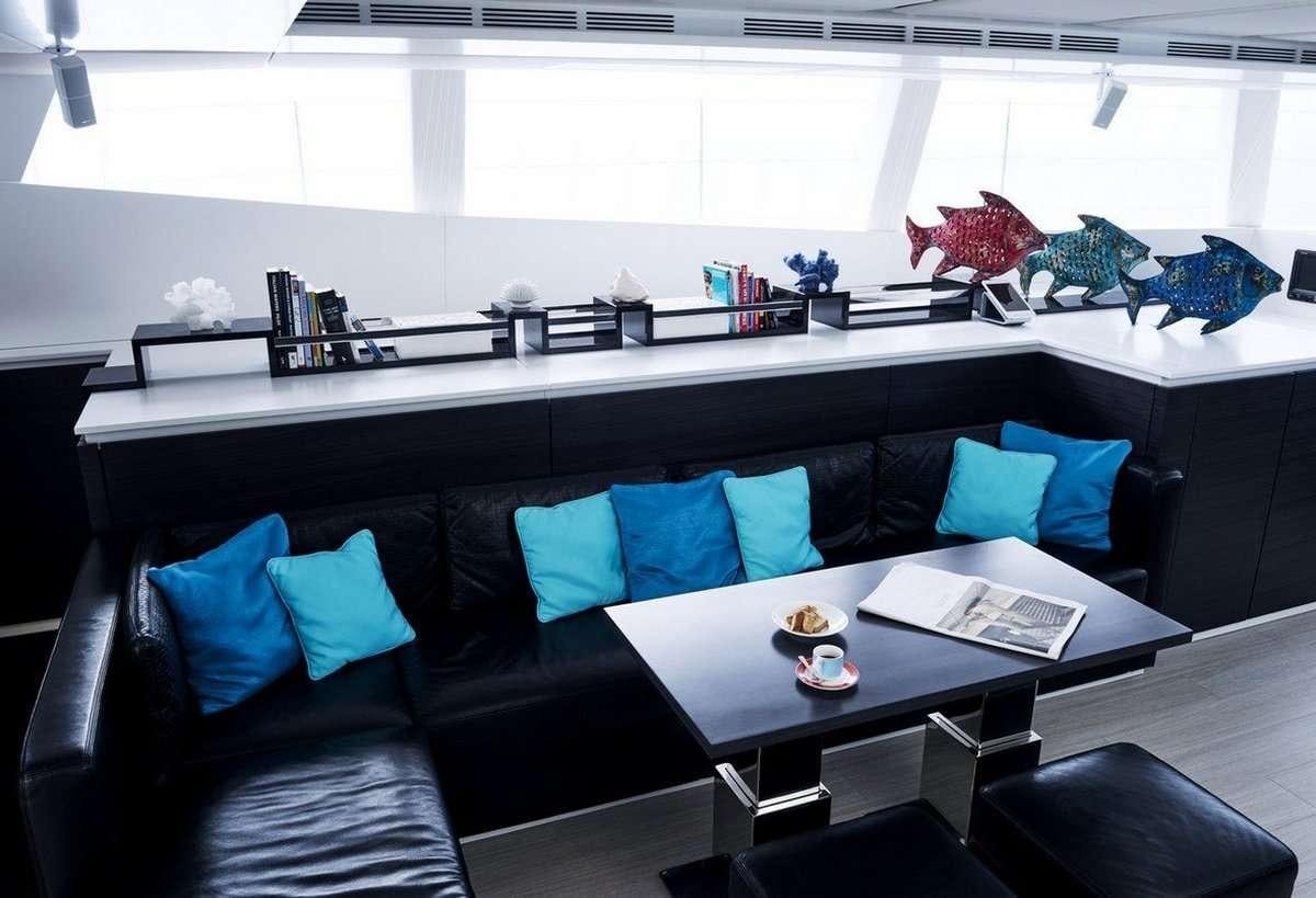 a room with a couch and a table aboard 19TH HOLE Yacht for Charter