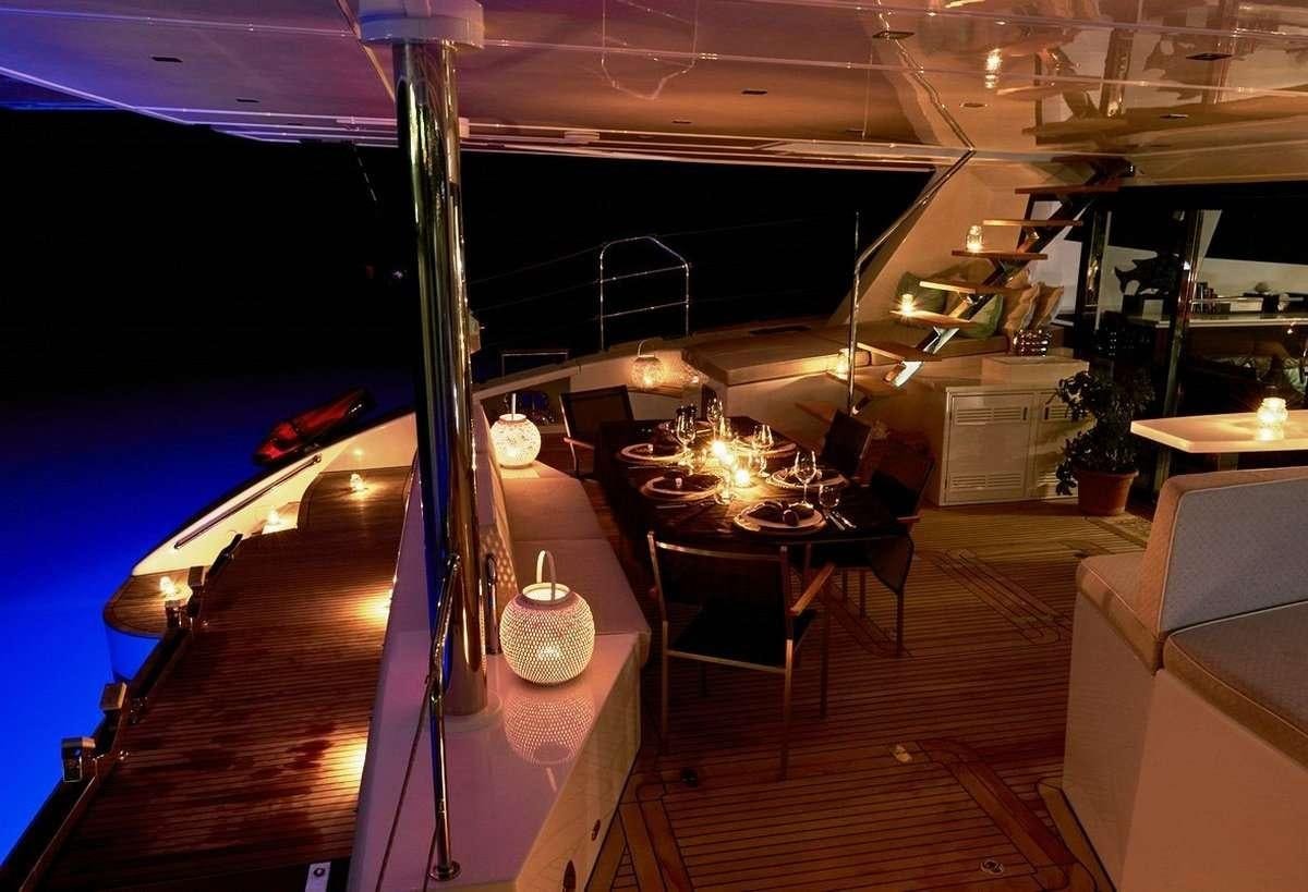 a room with a table and chairs aboard 19TH HOLE Yacht for Charter