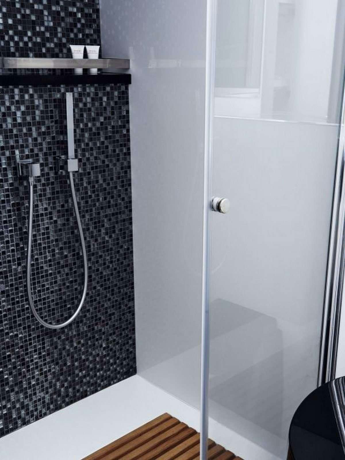 a shower with a black tile wall aboard 19TH HOLE Yacht for Charter