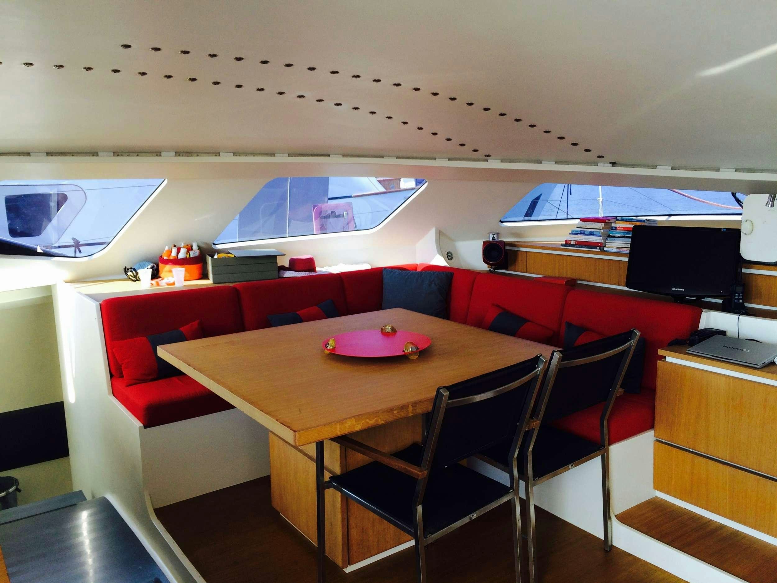 a room with a table and chairs aboard Obi One Yacht for Charter