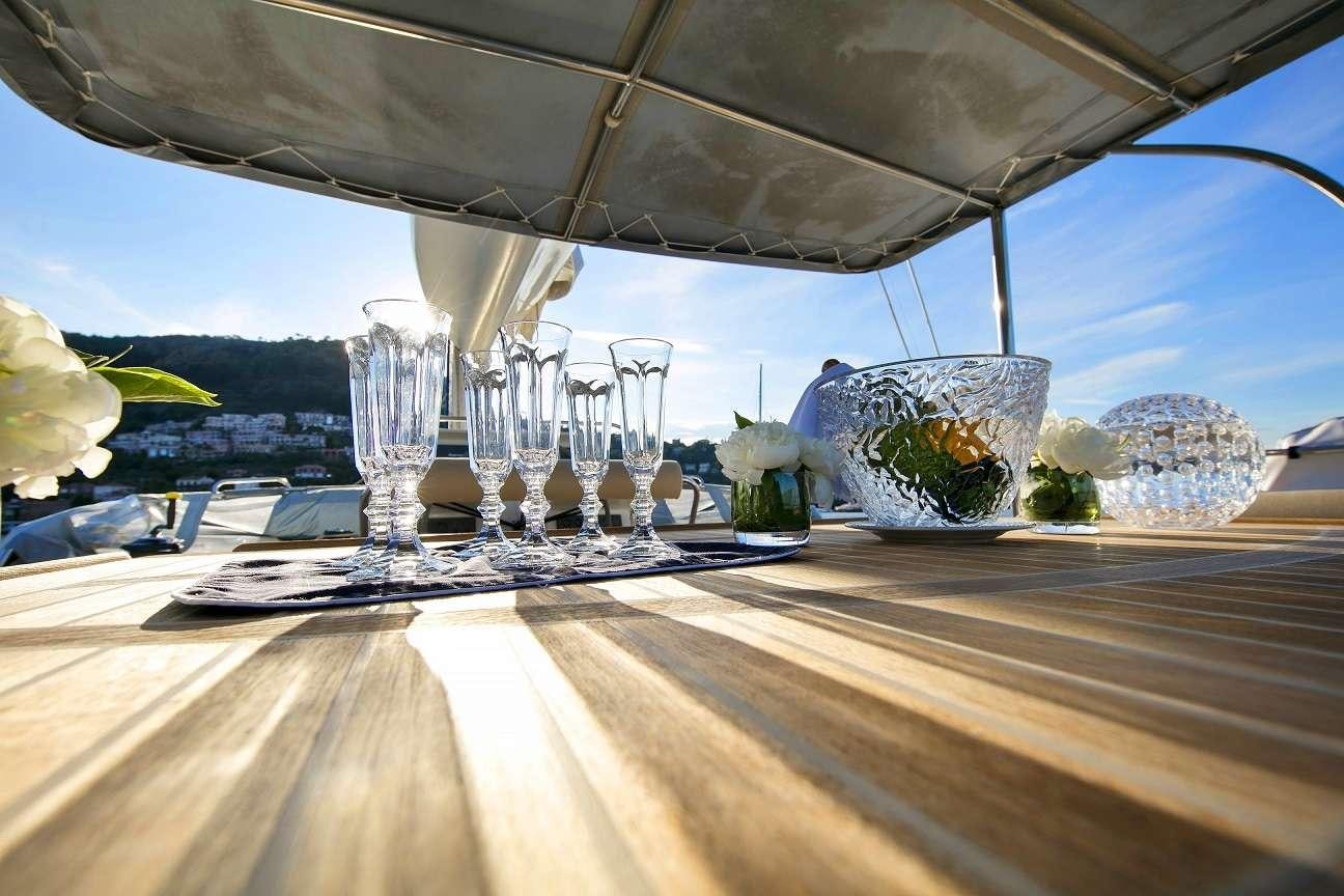 a table with glasses and a view of the water aboard Free Spirit Yacht for Charter