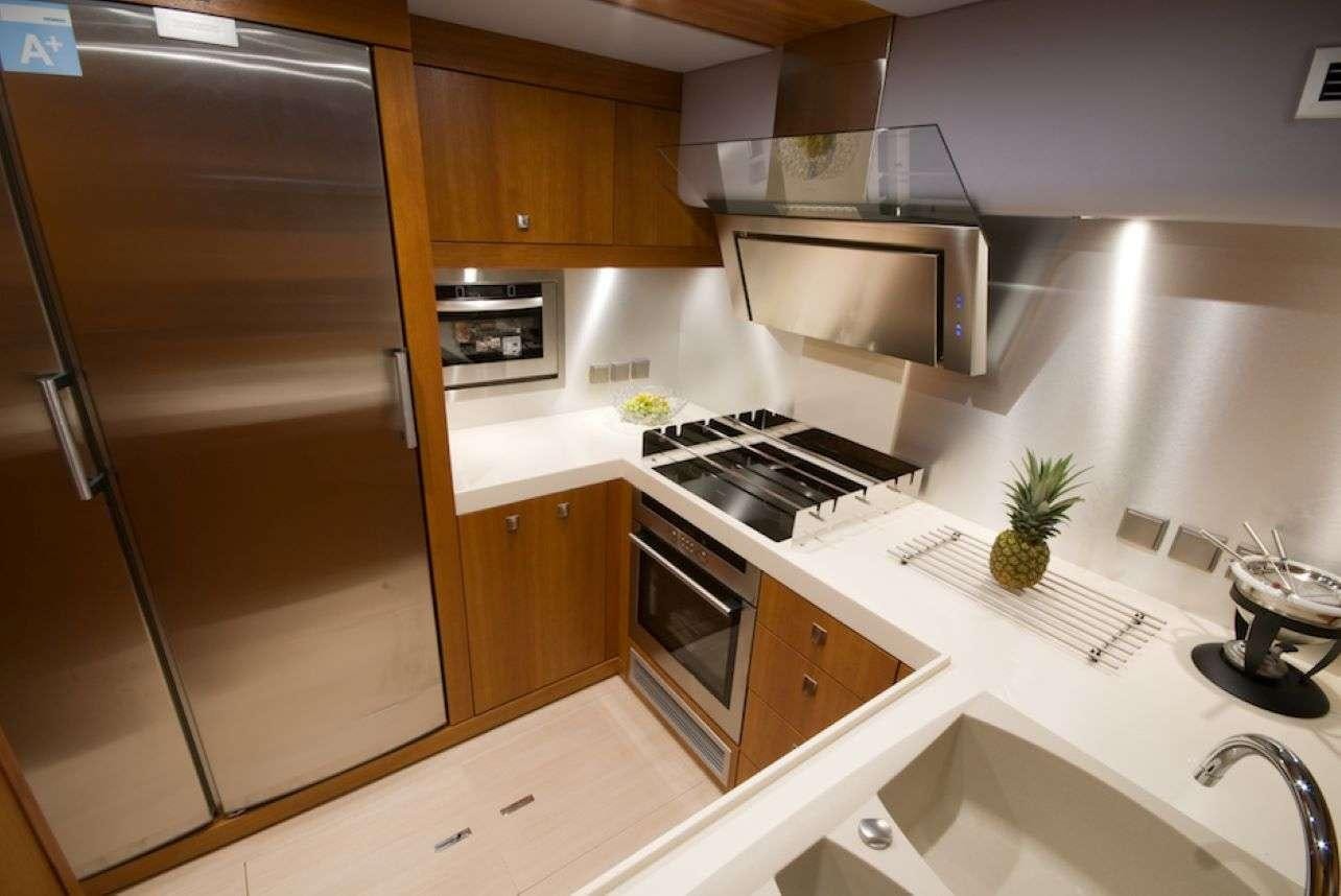 a kitchen with a stainless steel refrigerator aboard Free Spirit Yacht for Charter