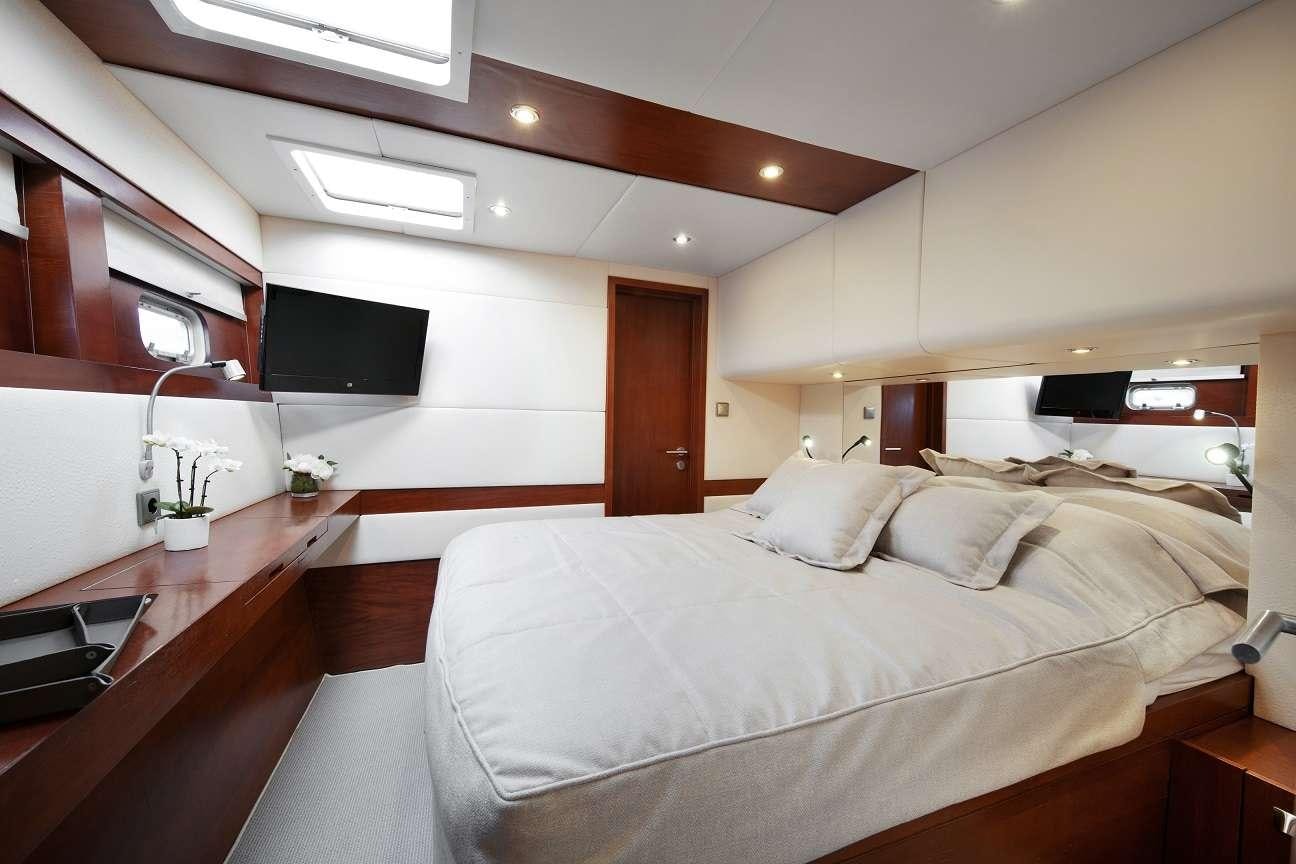 a bedroom with a large bed aboard Free Spirit Yacht for Charter
