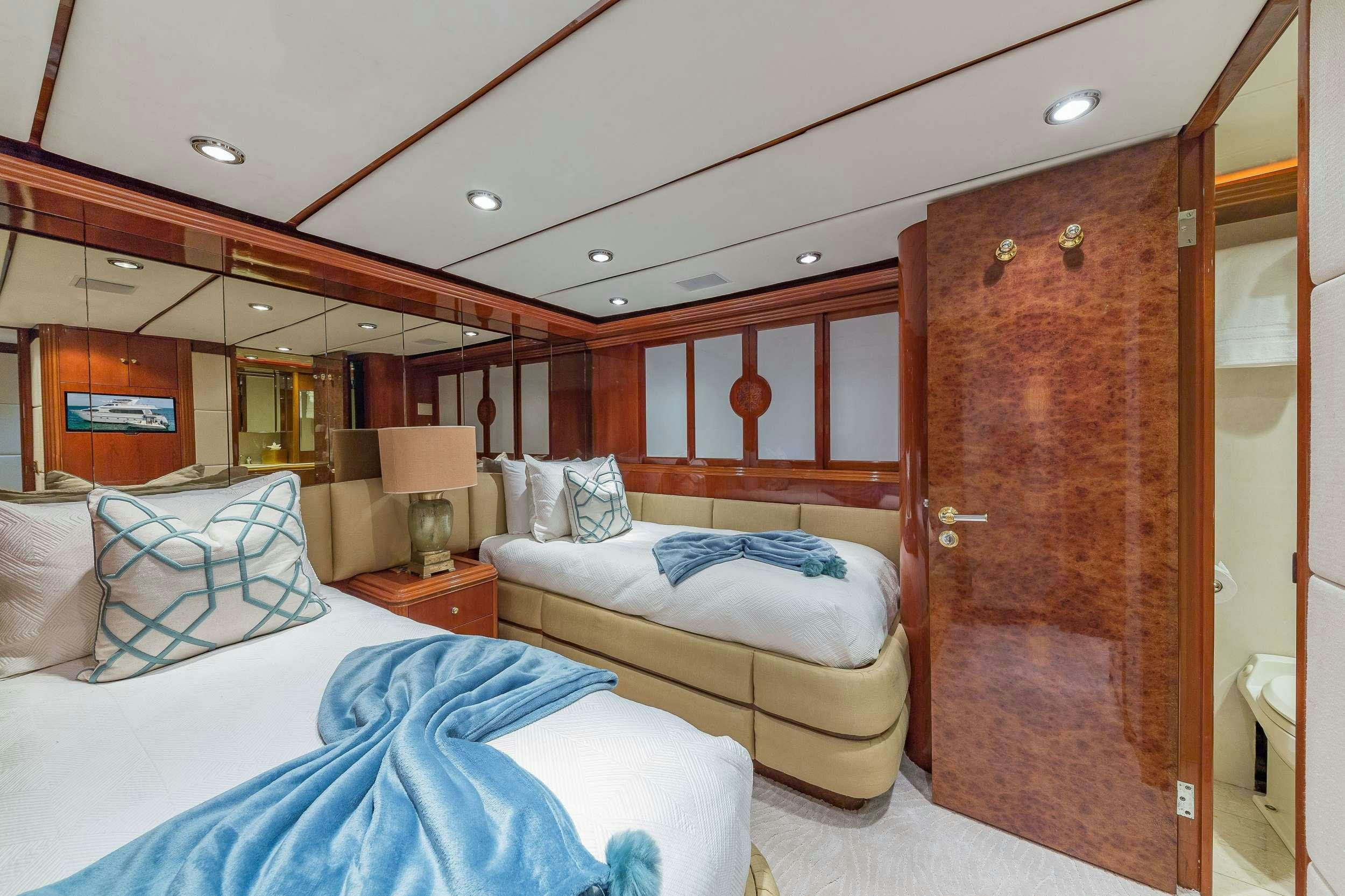 a room with a bed and a wood door aboard QUINTESSA Yacht for Charter