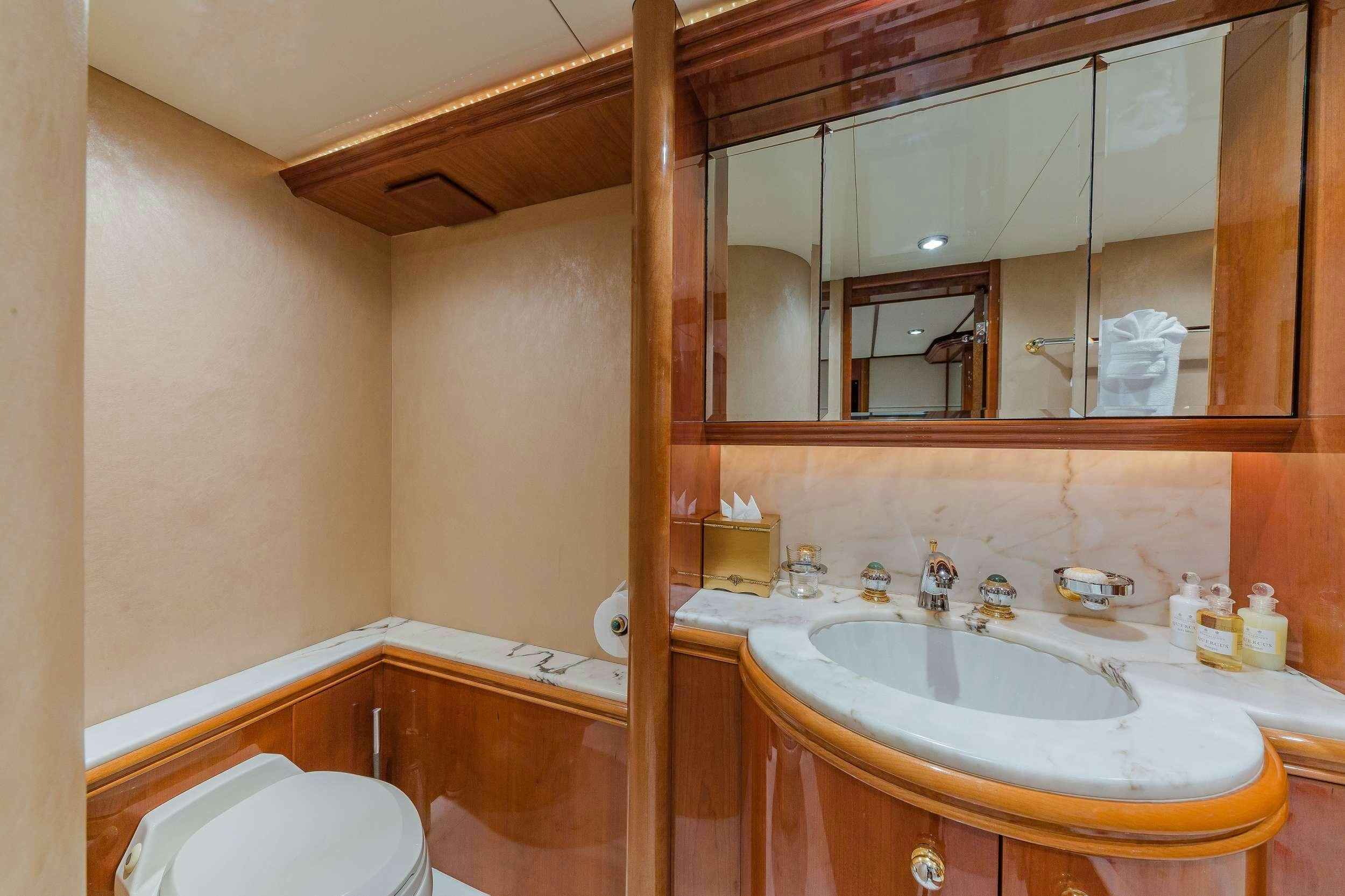 a bathroom with a tub sink and toilet aboard QUINTESSA Yacht for Charter