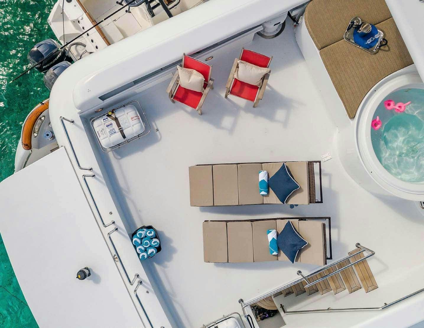 a white sink with a mirror and a towel on it aboard QUINTESSA Yacht for Charter