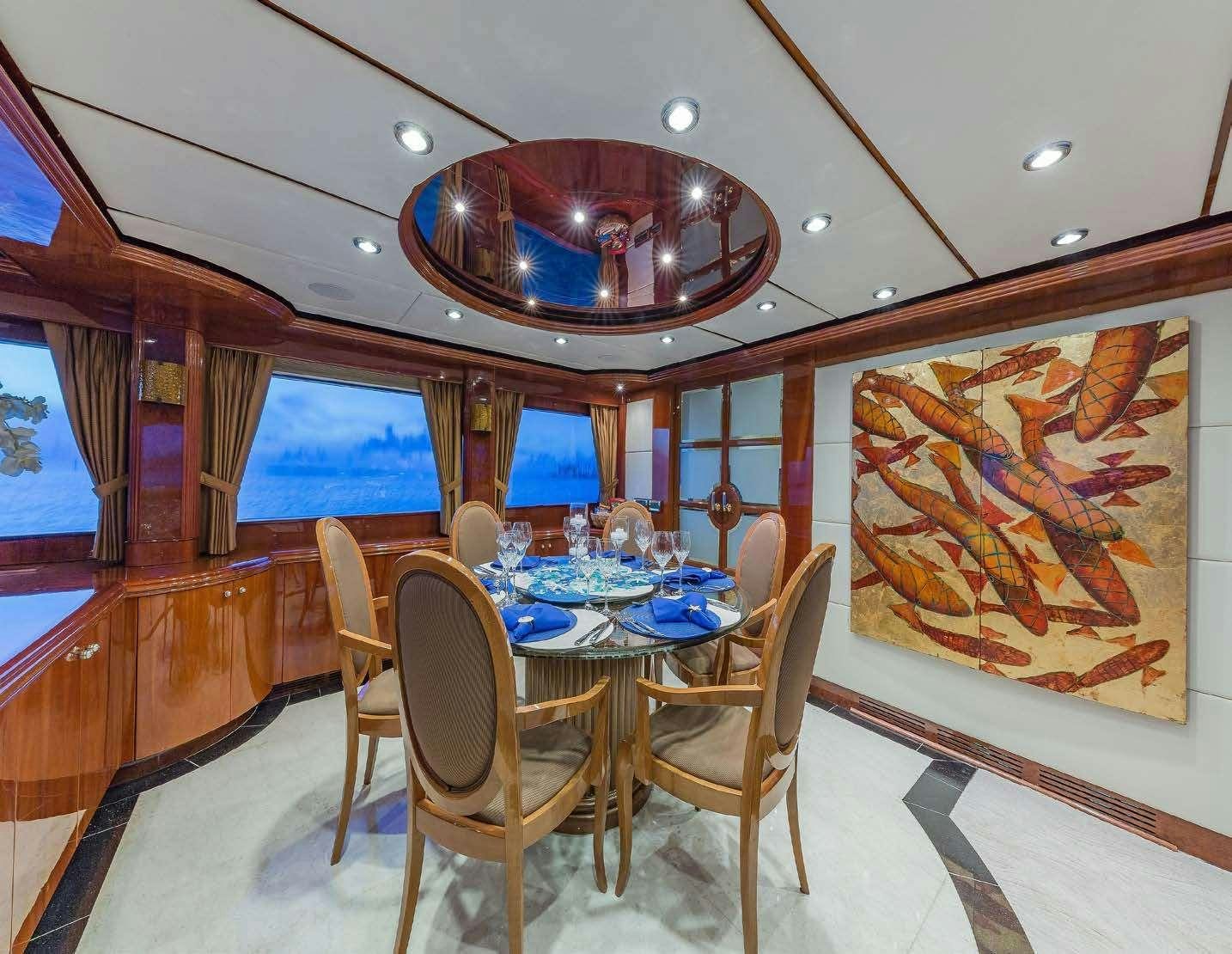 a dining room with a table and chairs aboard QUINTESSA Yacht for Charter