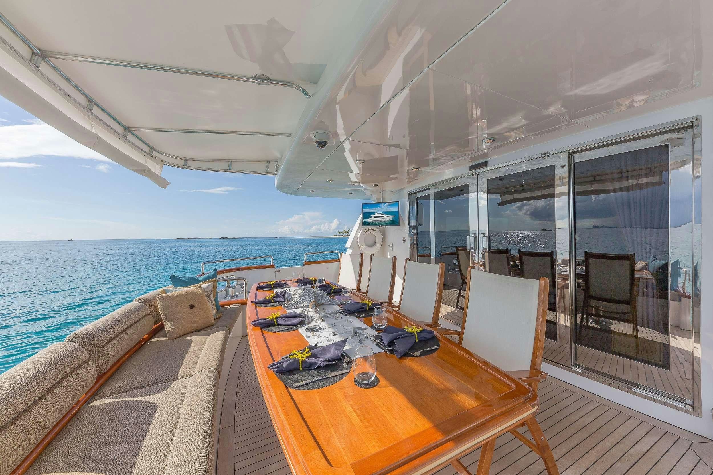 a table and chairs on a boat aboard QUINTESSA Yacht for Charter