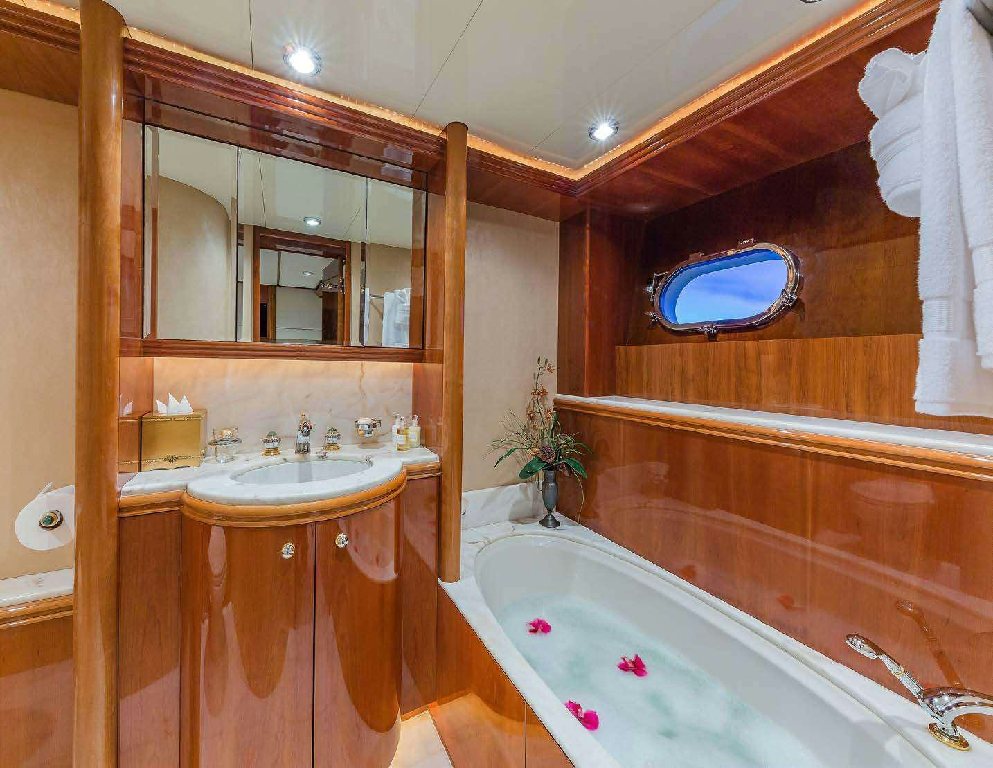 a bathroom with a tub sink and a mirror aboard QUINTESSA Yacht for Charter