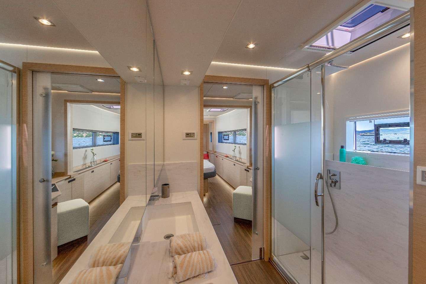 a large bathroom with glass doors aboard INSPIRANTE Yacht for Charter